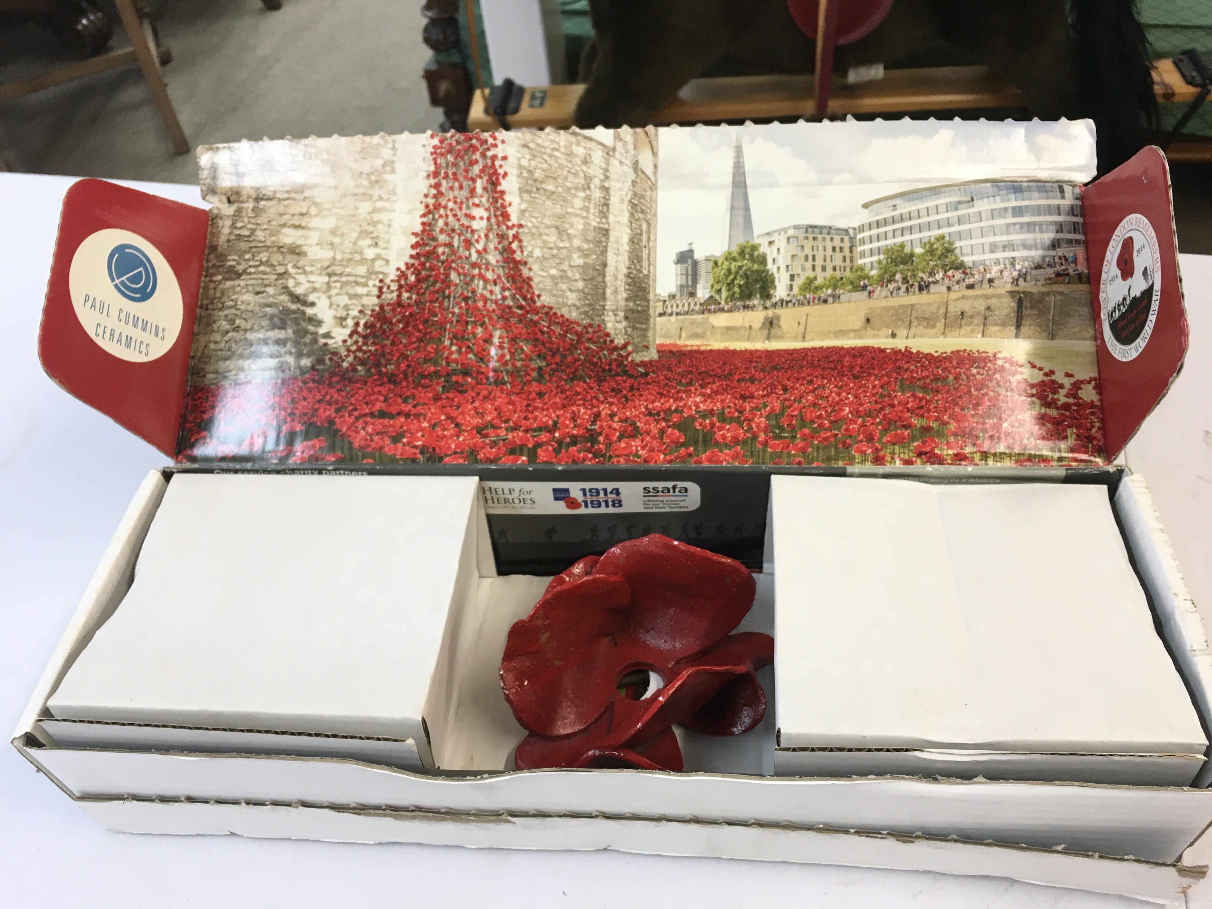 A boxed Paul Cummings poppy . Postage category C