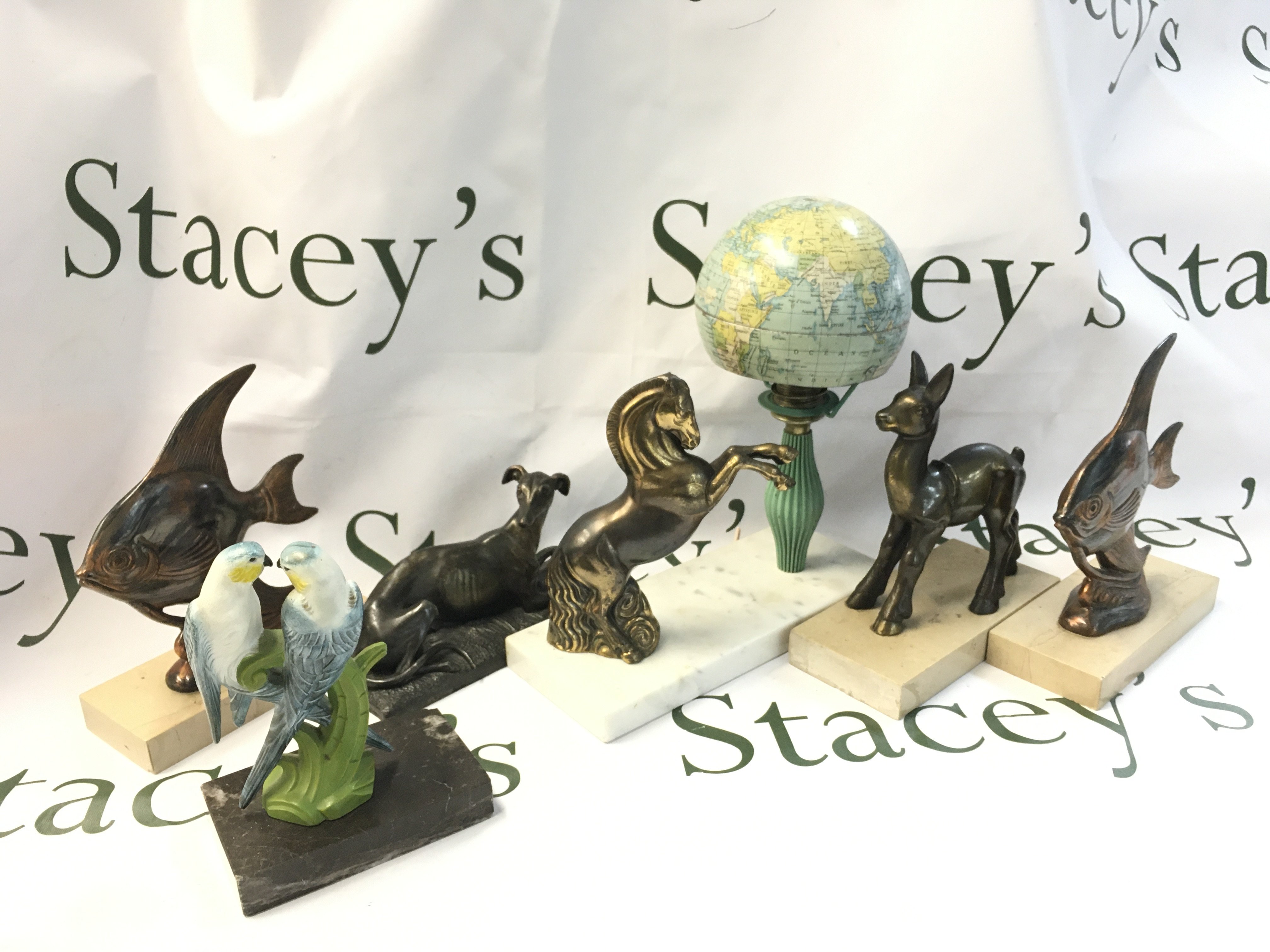 A collection of figures on plaques including a horse, grey ground , fish etc. postage category C