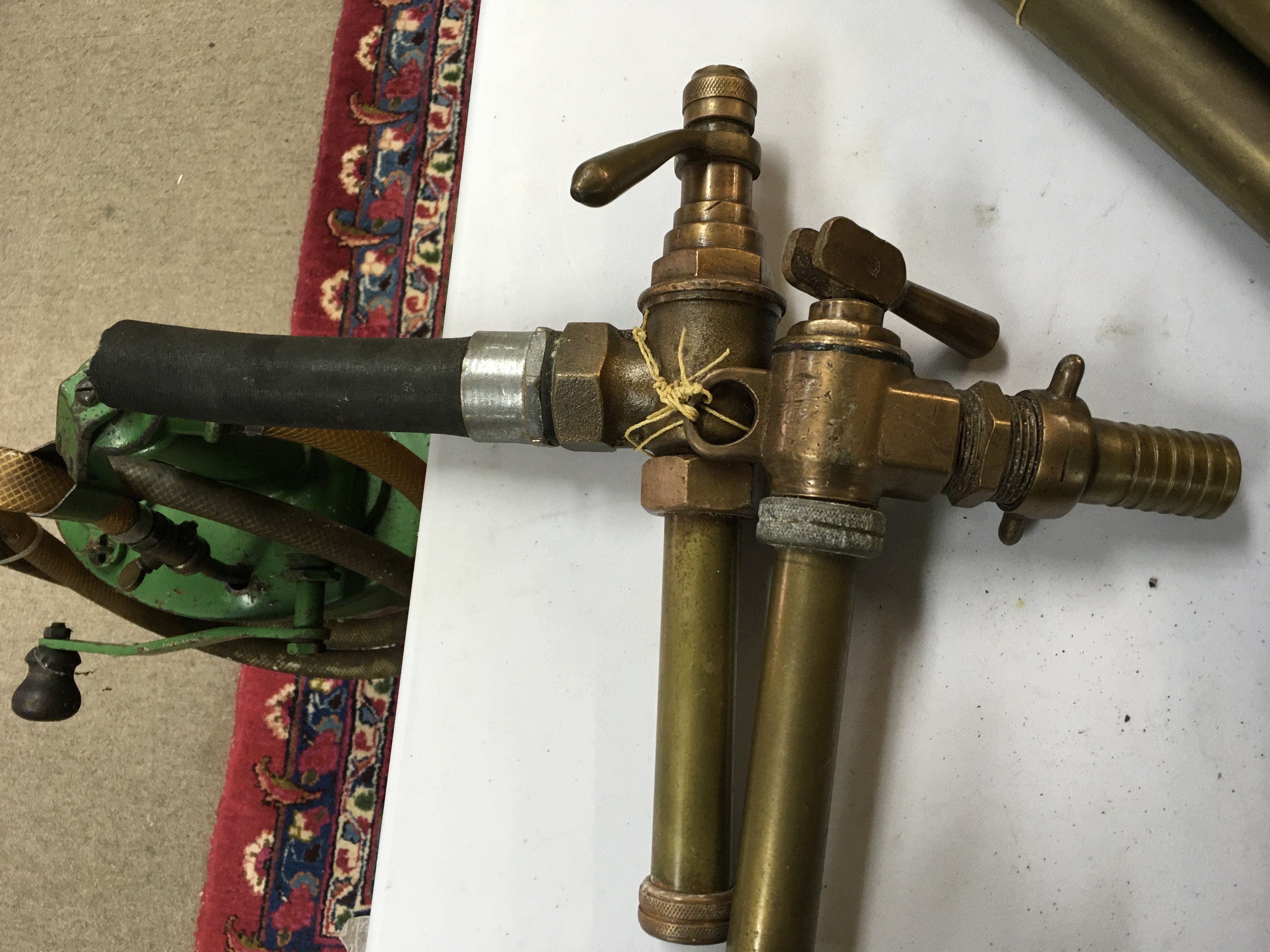 Two heavy brass pumps possibly for petrol. No reserve postage category C