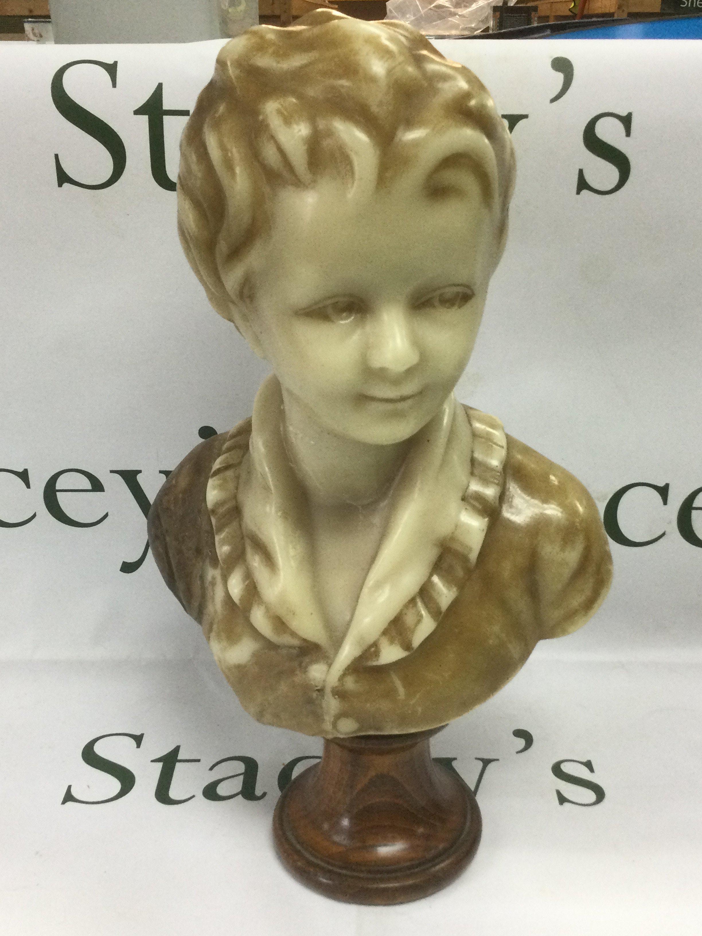 A wax head bust of a child mounted on a plinth, total approx height 39cm. Shipping category D.