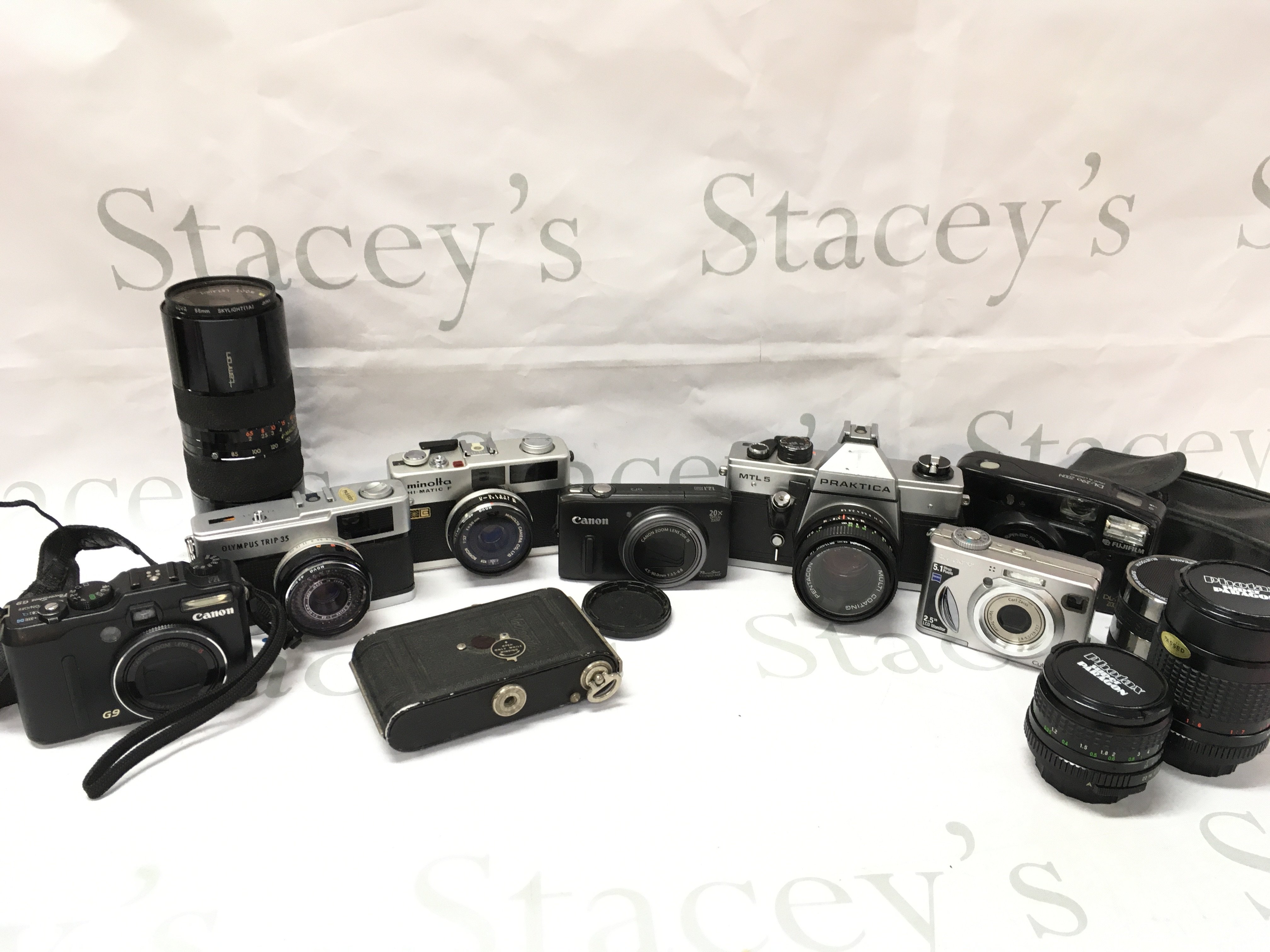 A collection of vintage and modern cameras including A Canon G9, Canon SX 260 HS, Olympus trip 35, Praktica MLT 5, Minolta Hi-Matic F , Tamron 210mm lens, Photax 135mm lens and other accessories etc. Postage cat c