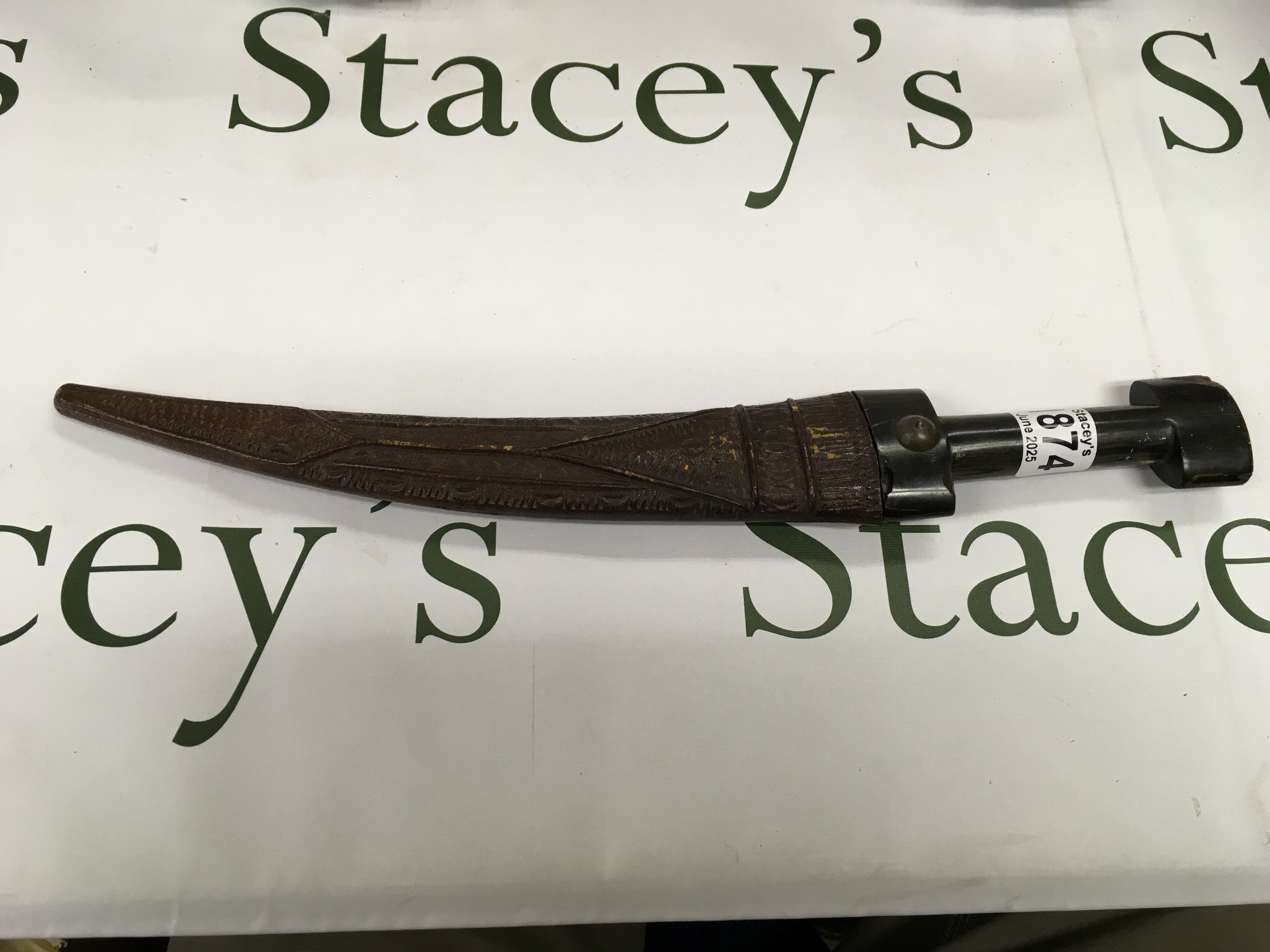 An African style Kursk with a horn handle and a leather patterned scabbard.