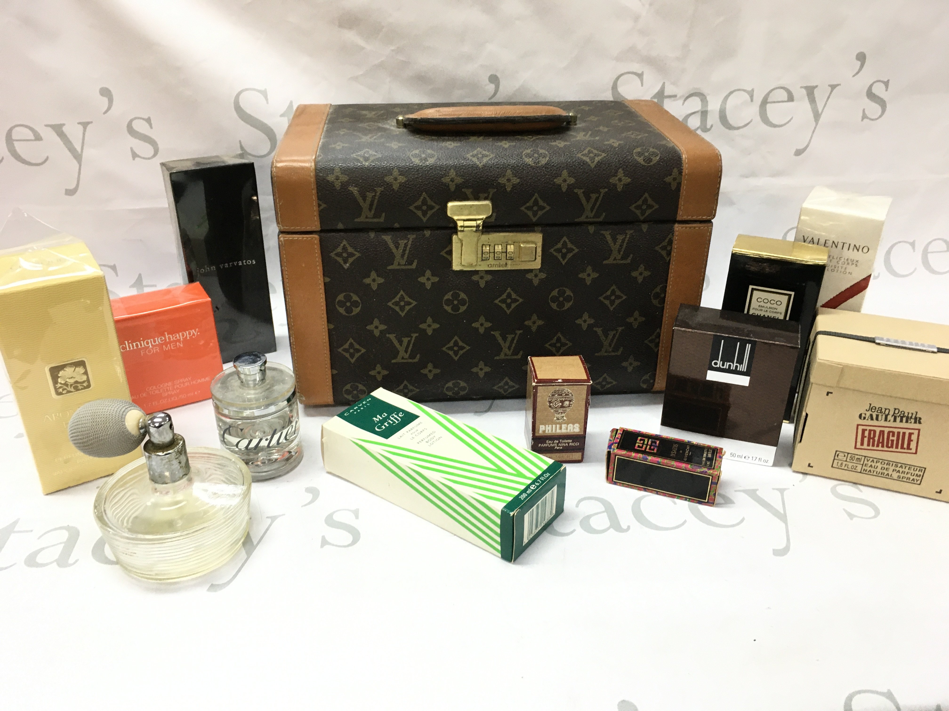 A replica Louie Vuitton case with boxed perfumes including Coco Chanel, Jean Paul, Cartier etc