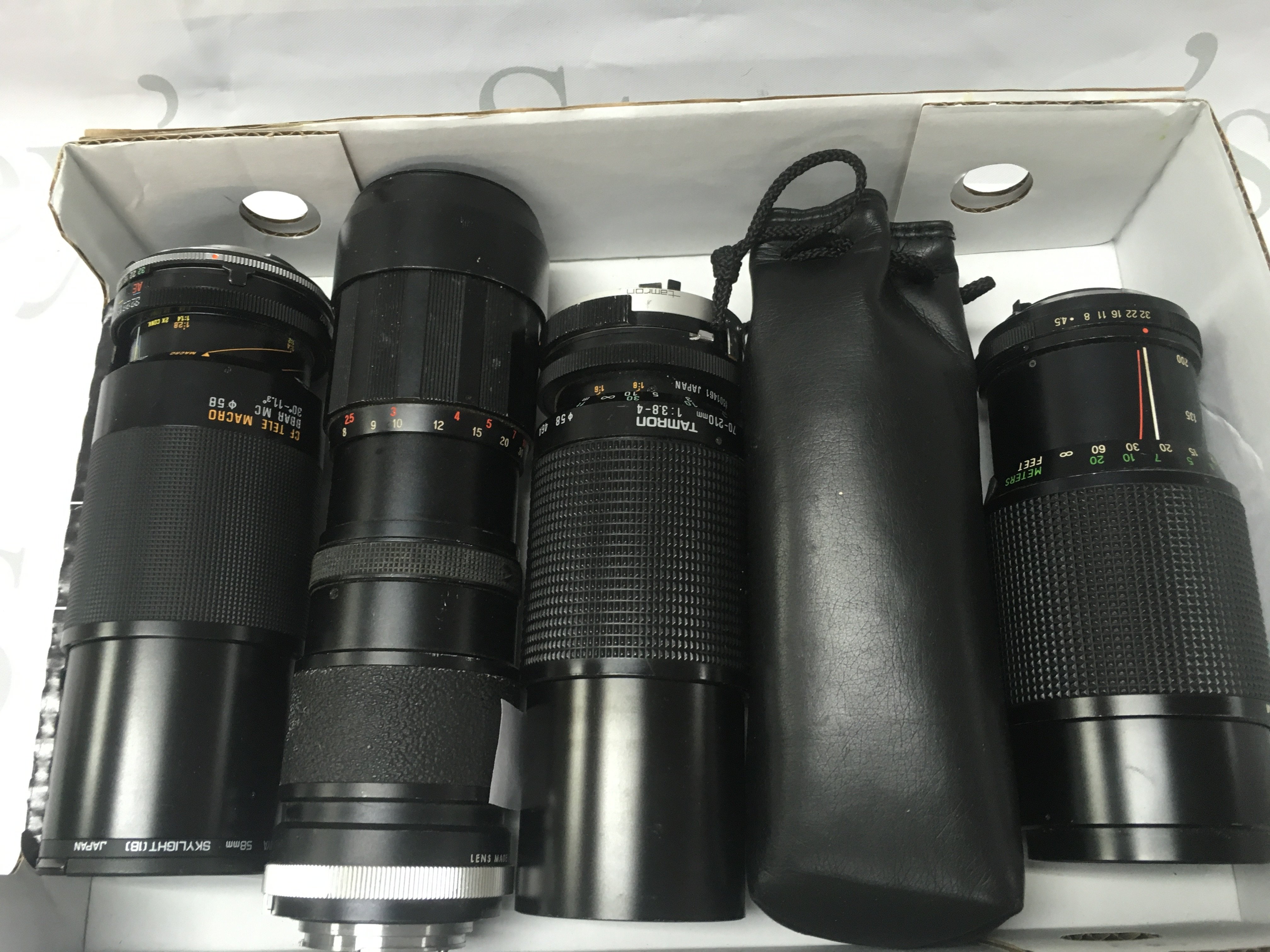 Four various camera lenses including Vivitar 200mm, Tamron 210mm, Panagor 205mm. Postage category B