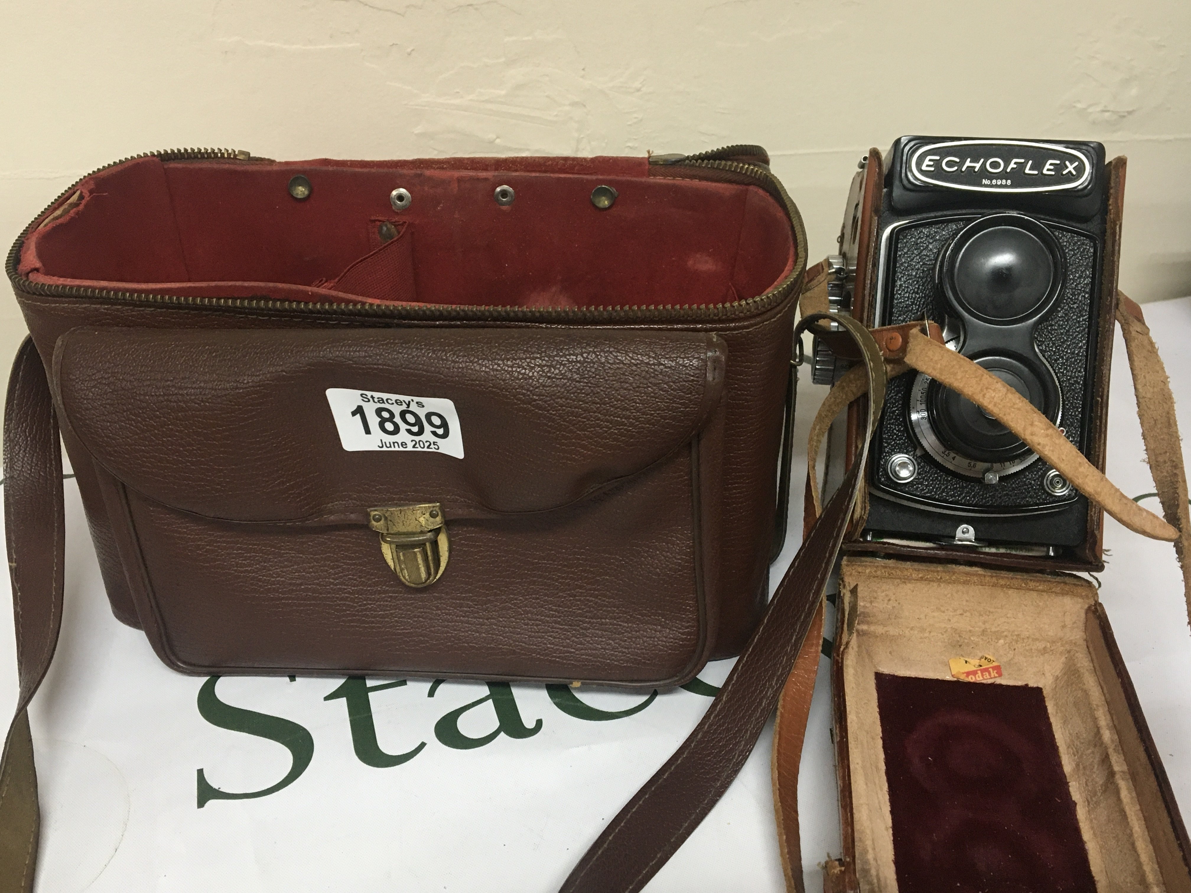 An Echoflex camera serial number 6988 in a fitted case and with camera case and a few accessories.