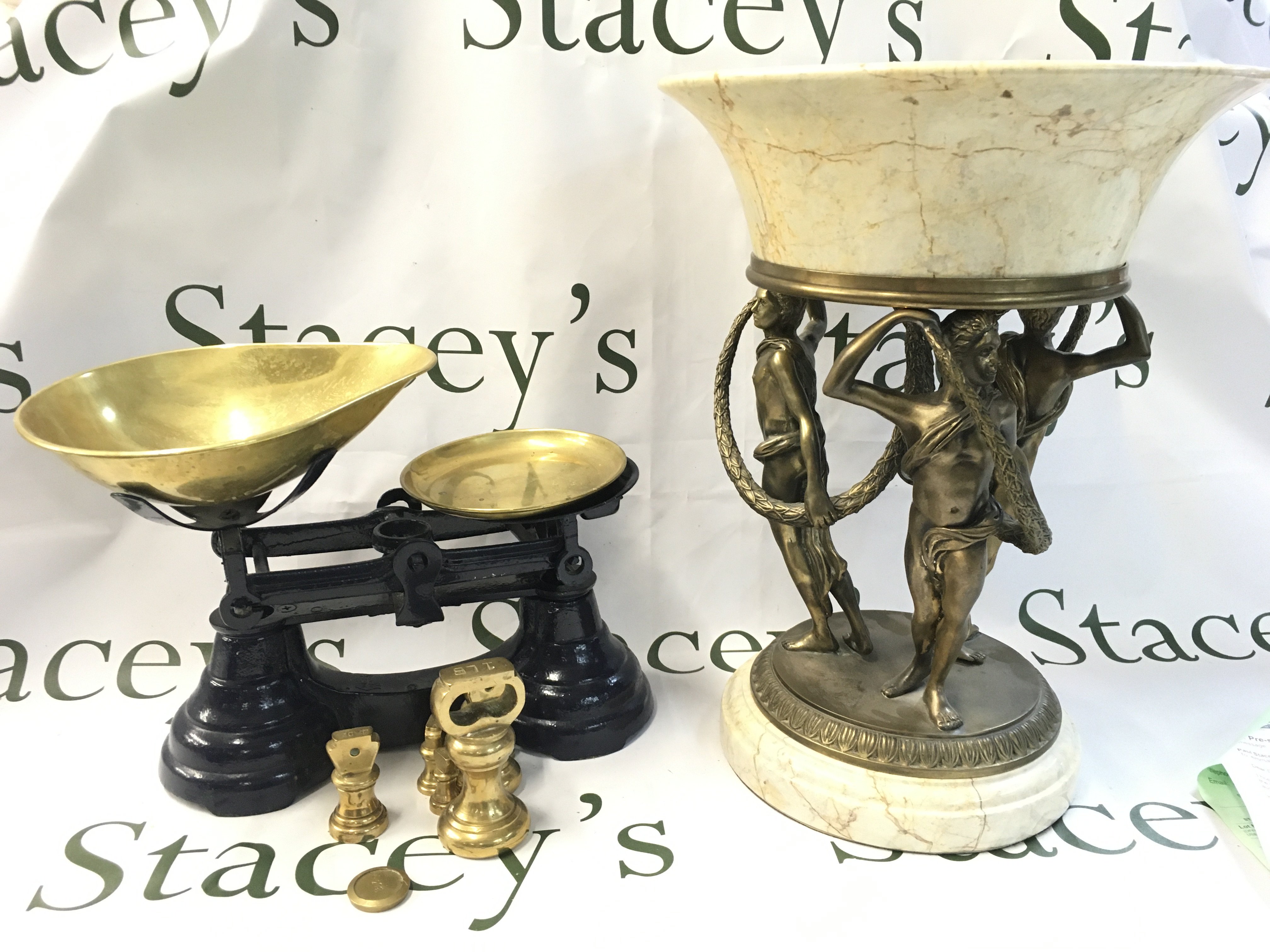 A set of scales and a marble bowl with three simulated bronze figures ornament. This lot cannot be posted