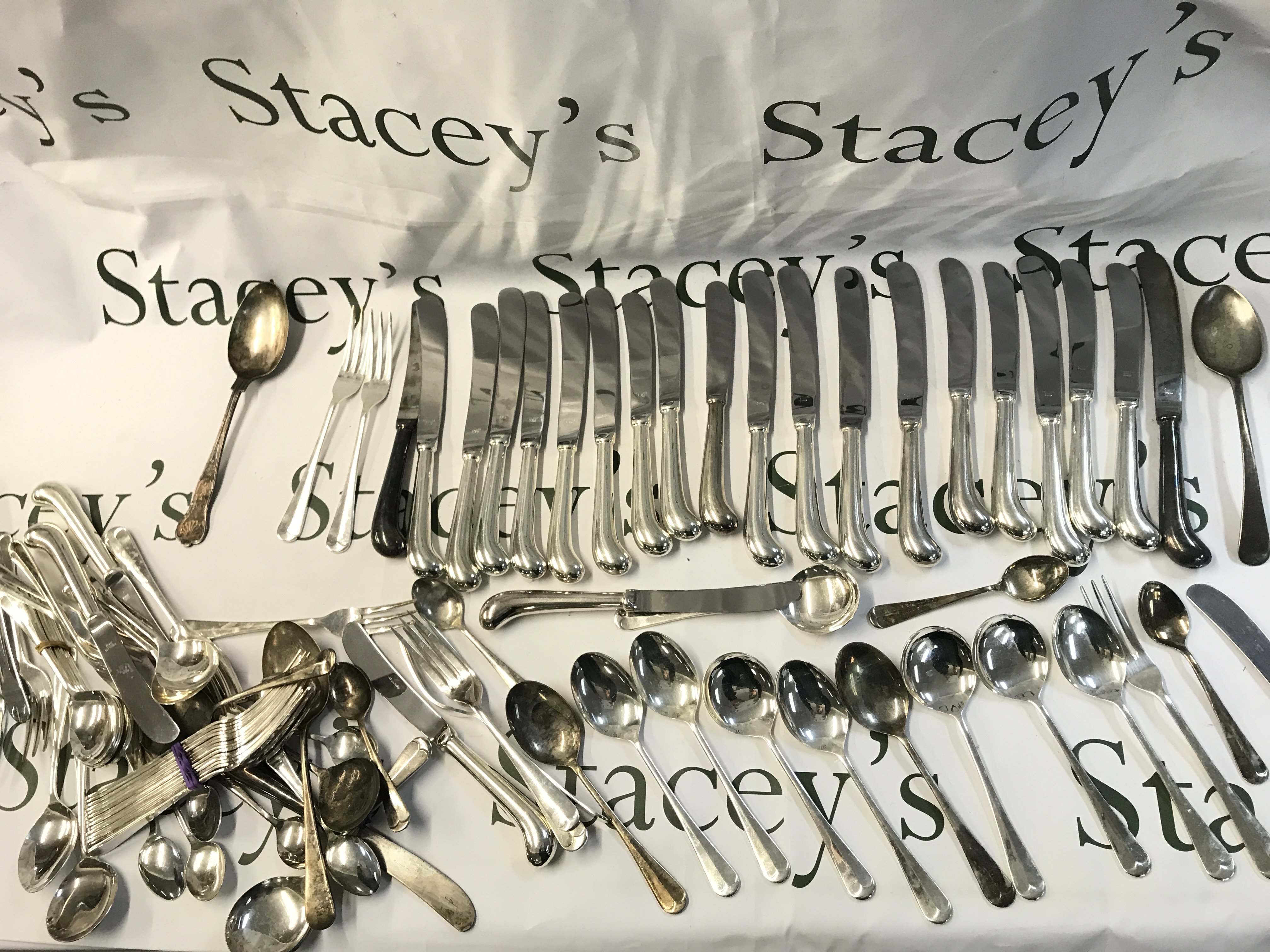 A collection of cutlery including spoons, forks, knives etc. postage category b