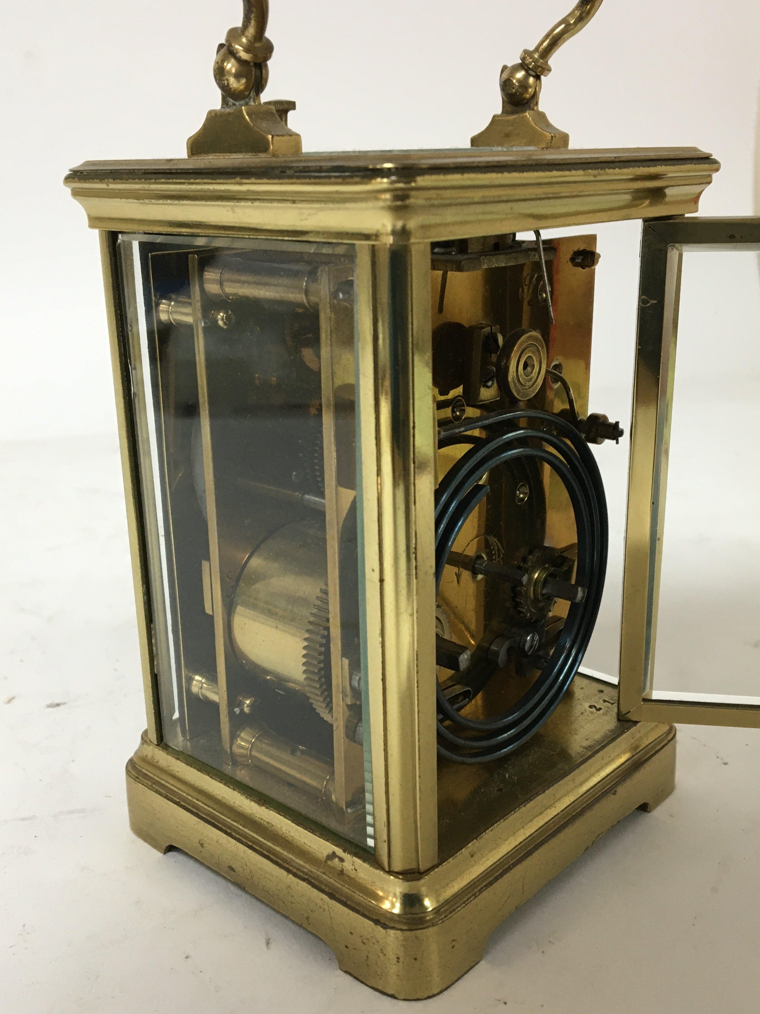 A French brass cased strike repeat carriage clock with a white enamel dial Hight 13cm