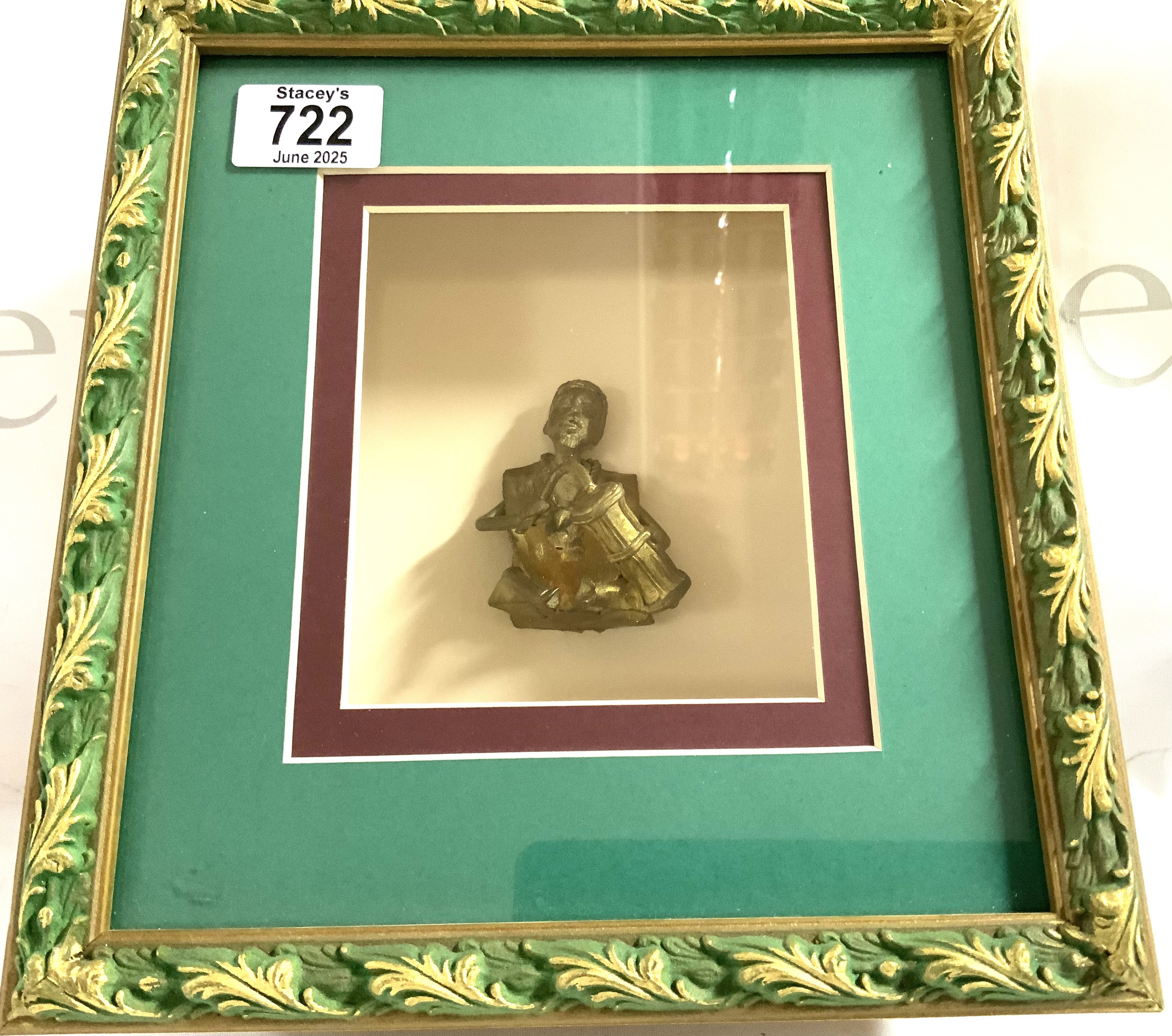 A small bronze West African seated figure of a man mounted within a shadow box display. (A)