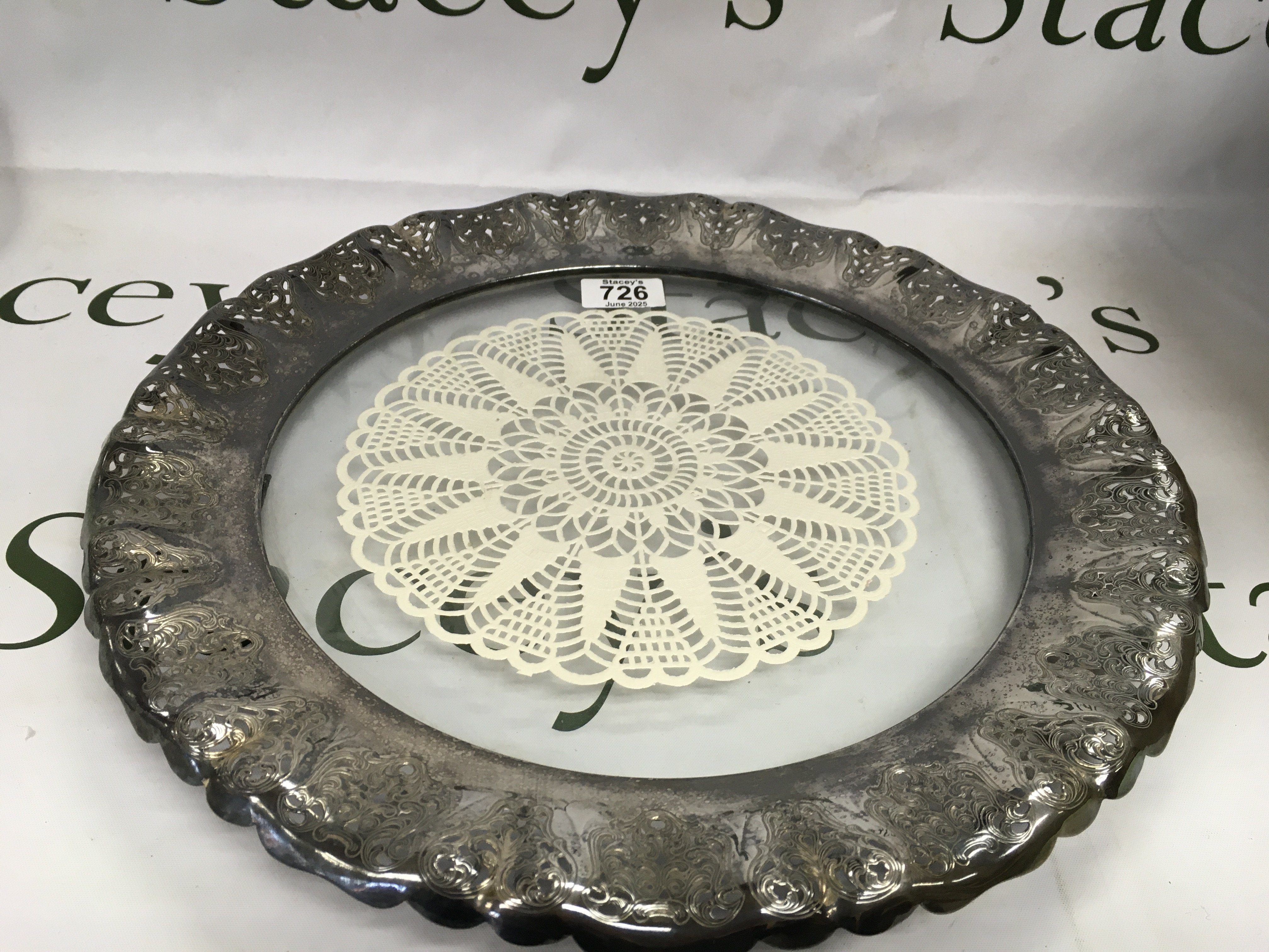 A glass tray with a silver plate rim.