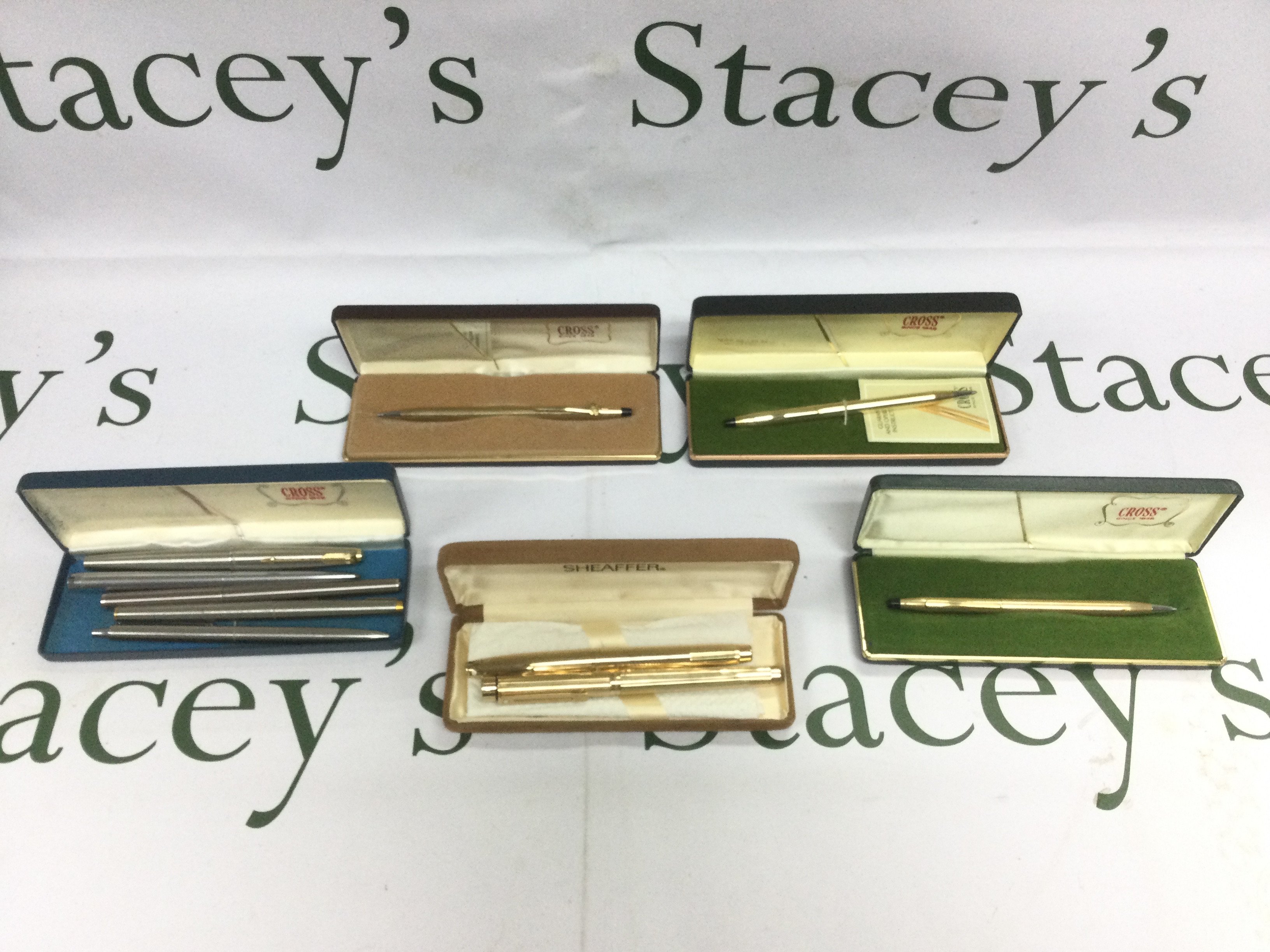 A collection of pens comprising two 14k gold nib Sheaffer fountain pens plus some Cross and Parker examples. Shipping category B.