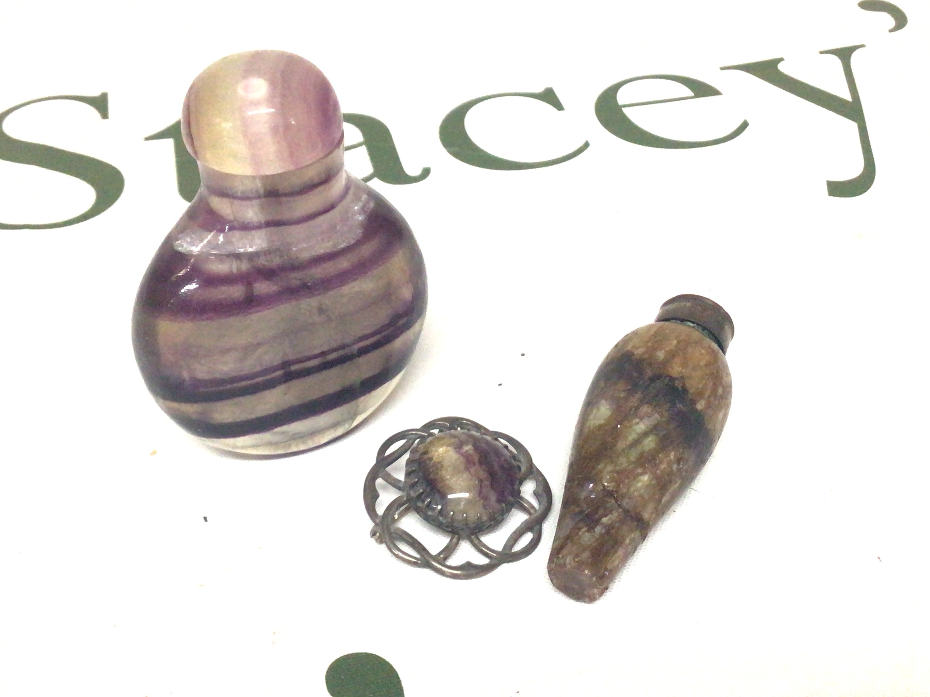 An intresting scent bottle most likely Blue John stone a conforming brooch and one other scent bottle possibly polished Amethyst. (3)