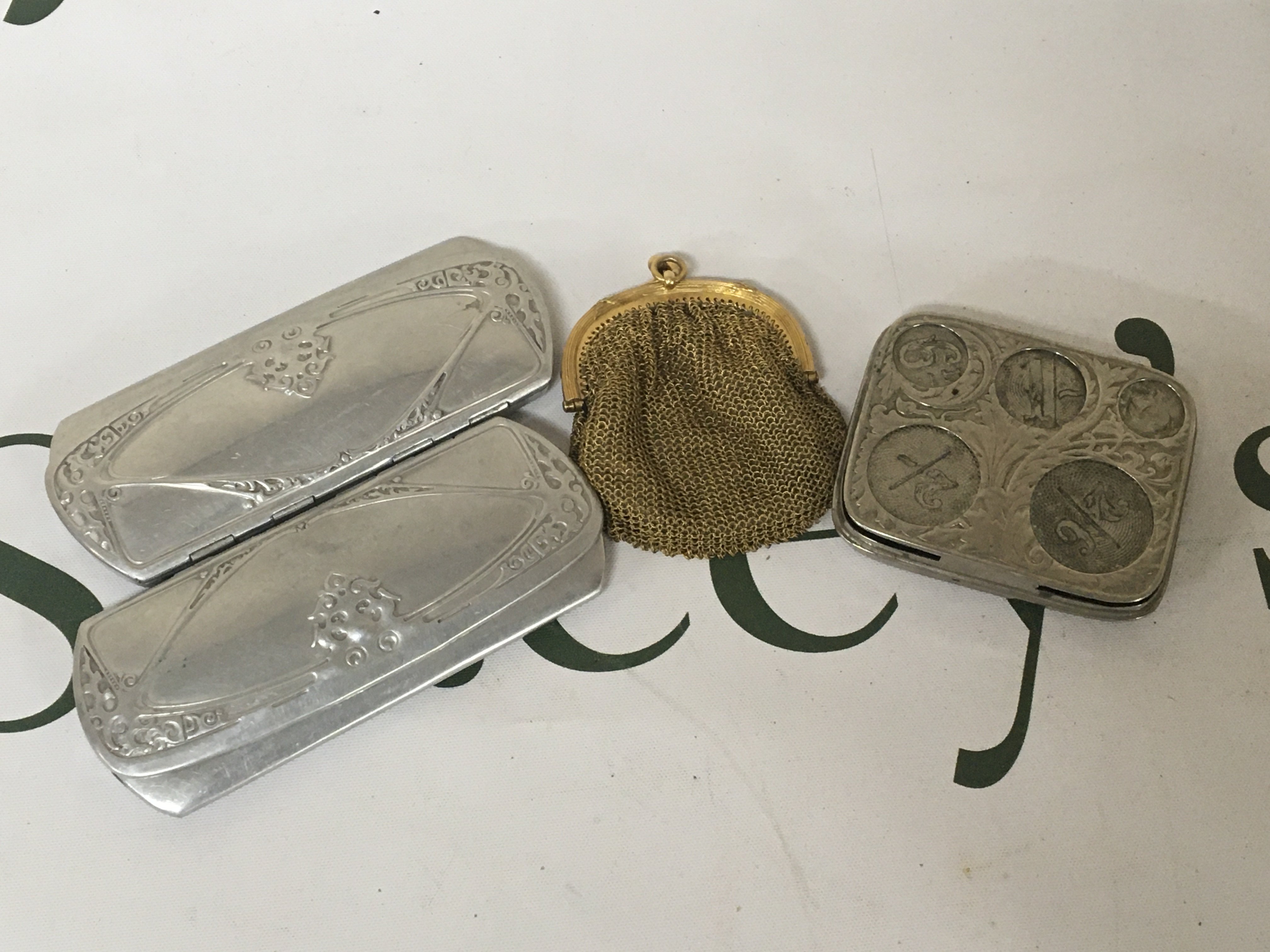 A coin case with sprung cavities a small purse and vintage glasses cases.