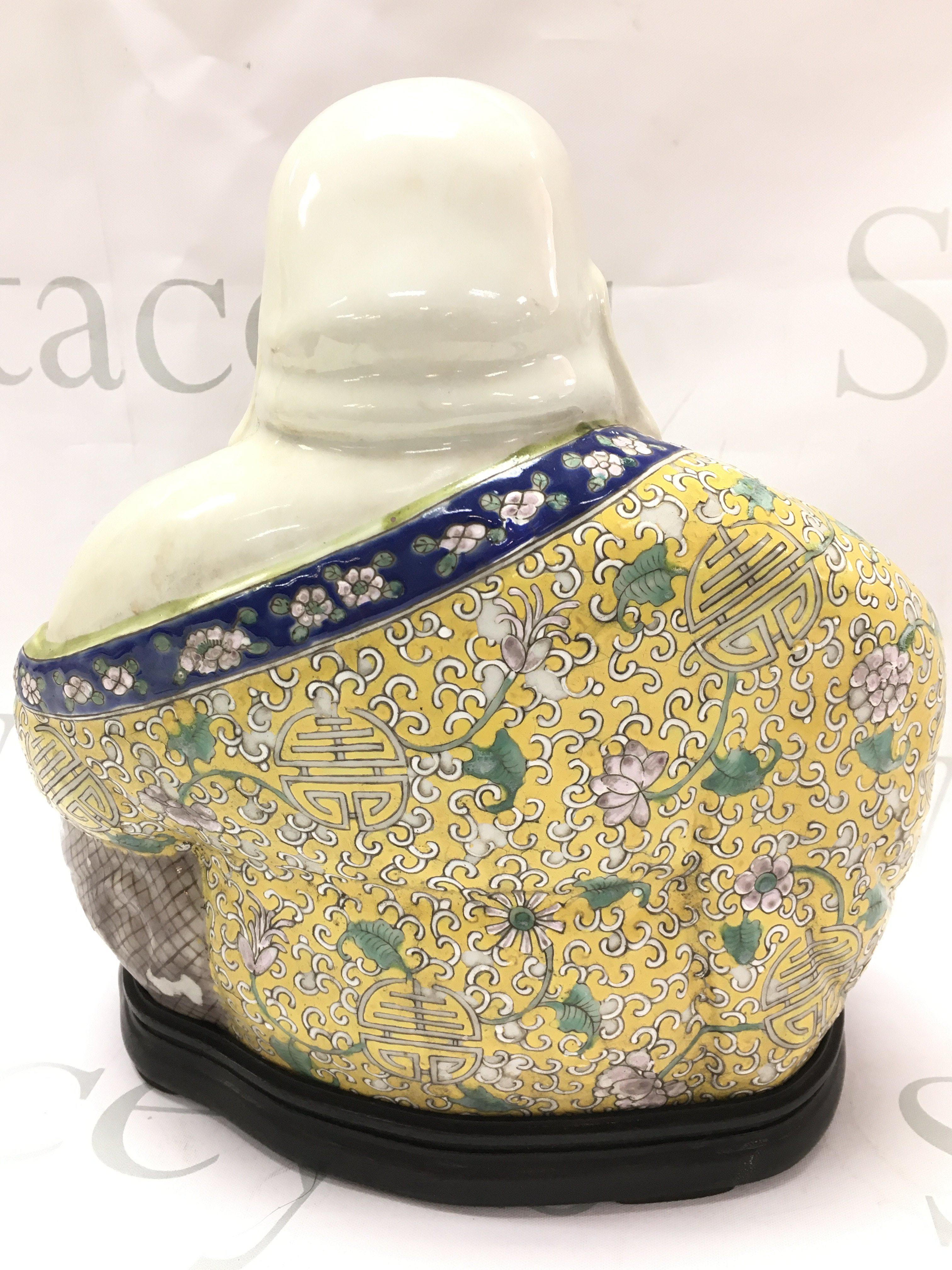 A Chinese ceramic Famille Rose Buddah figure, 25cm tall. Some chips in the paintwork. This lot cannot be posted