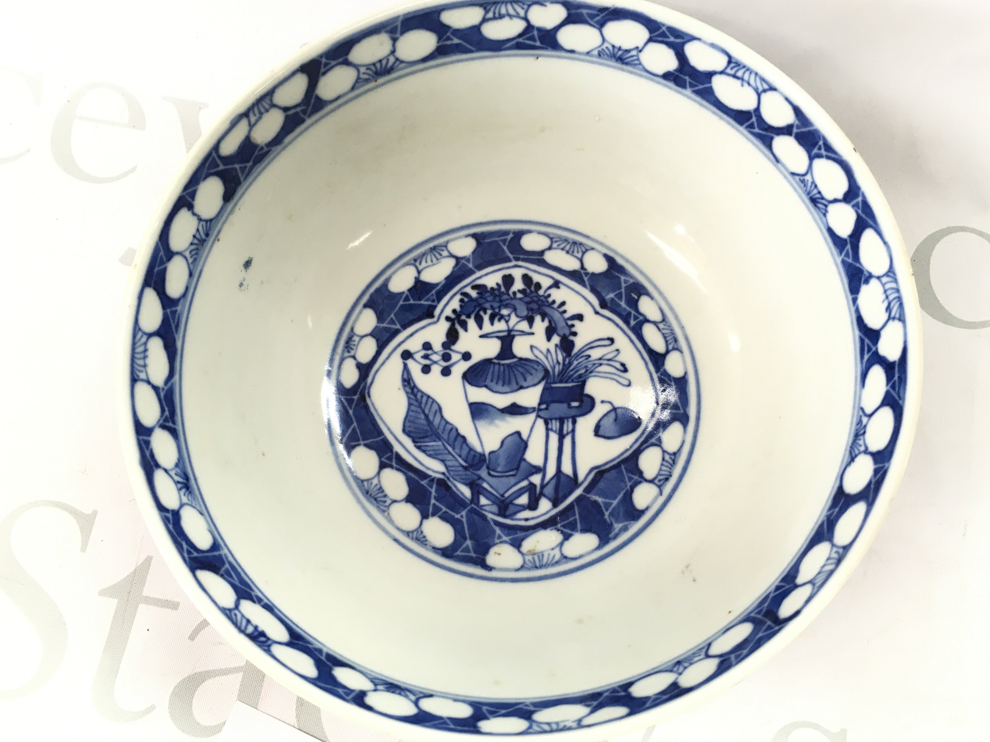 A 19th century Chinese blue and white bowl decorated with figures and cherry blossom. Four character mark at the base, 20.5cm wide. Small chips seen .This lot cannot be posted