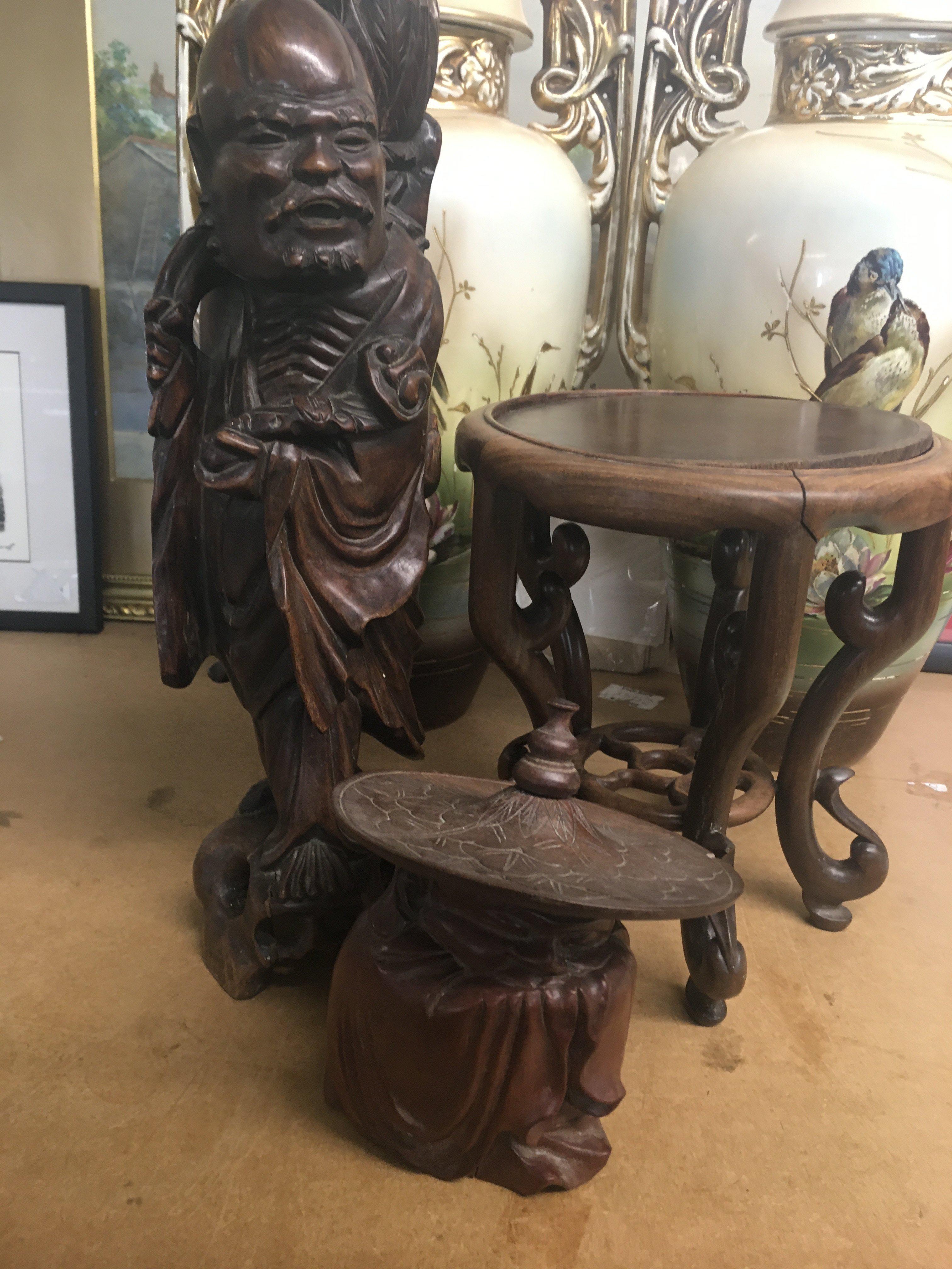 A Chinese root carving in the form of a elder a small stand and a jar and cover .