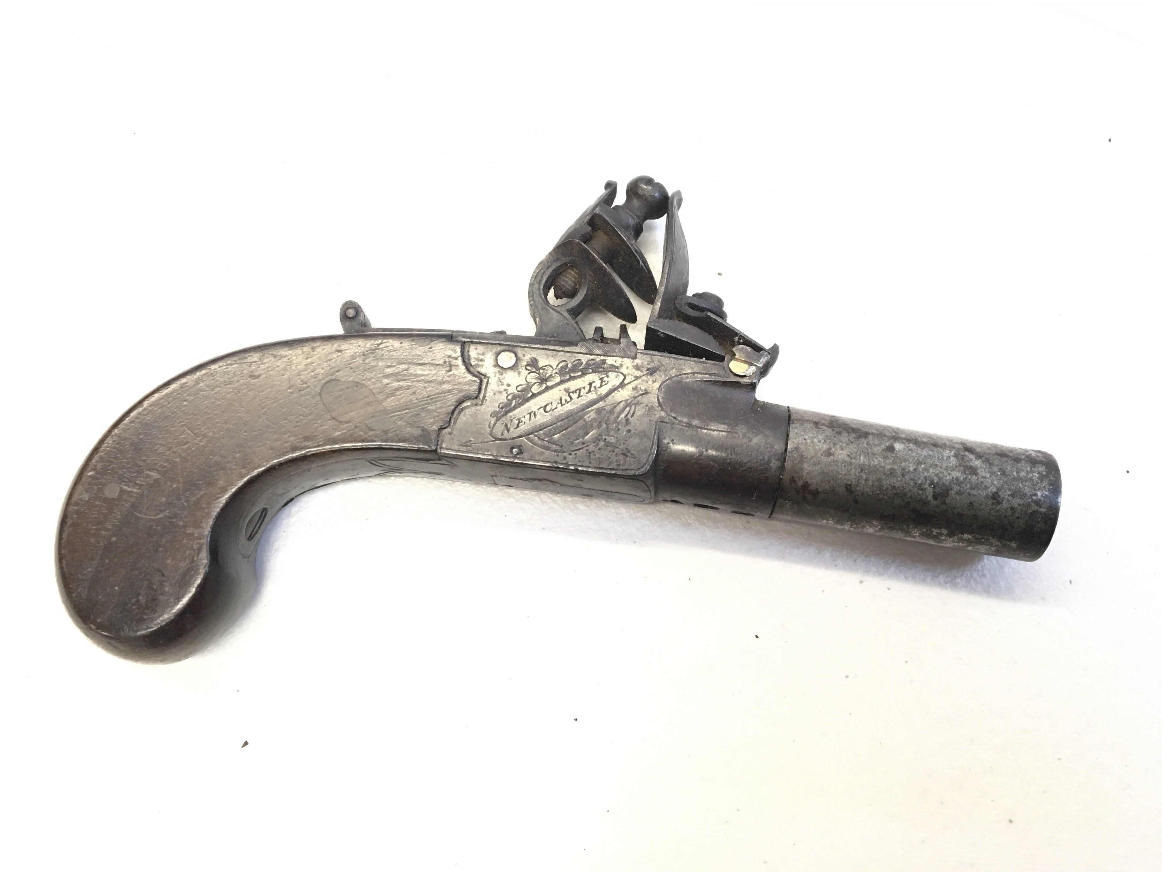 An early 19th century flintlock pocket pistol with retractable trigger screw barrel the action stamped Conway Newcastle action functional proof marks to the underside of the barrel.