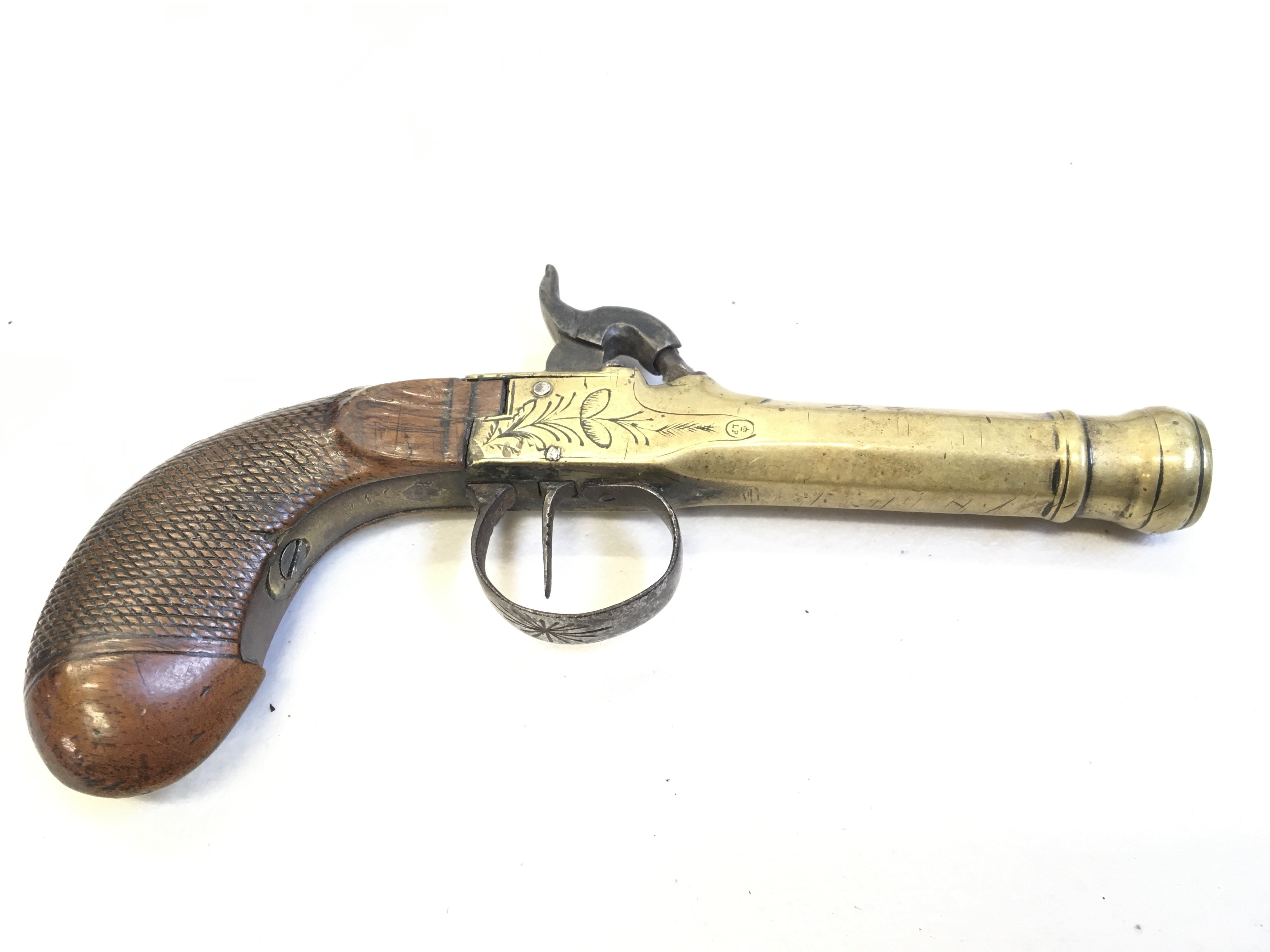 An Early 19th Century brass cannon barrel percussion pistol with a walnut grip steel trigger guard stamped LP to the barrel with light floral pattern engraving.