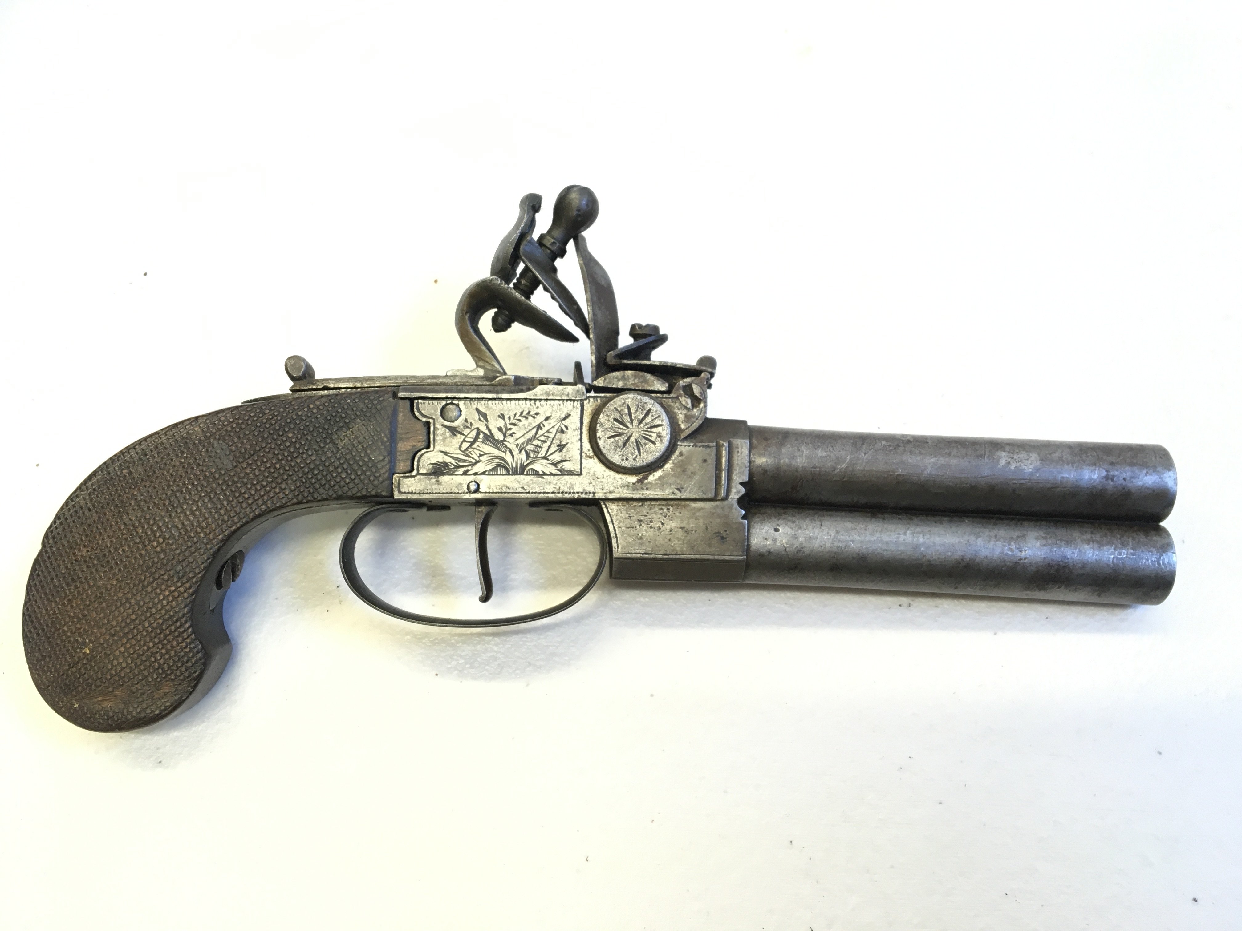 A rare double barrel single trigger late 18th or early 19th century flintlock pistol the steel action engraved no obvious makers marks with a walnut grip action functional but needs refreshing