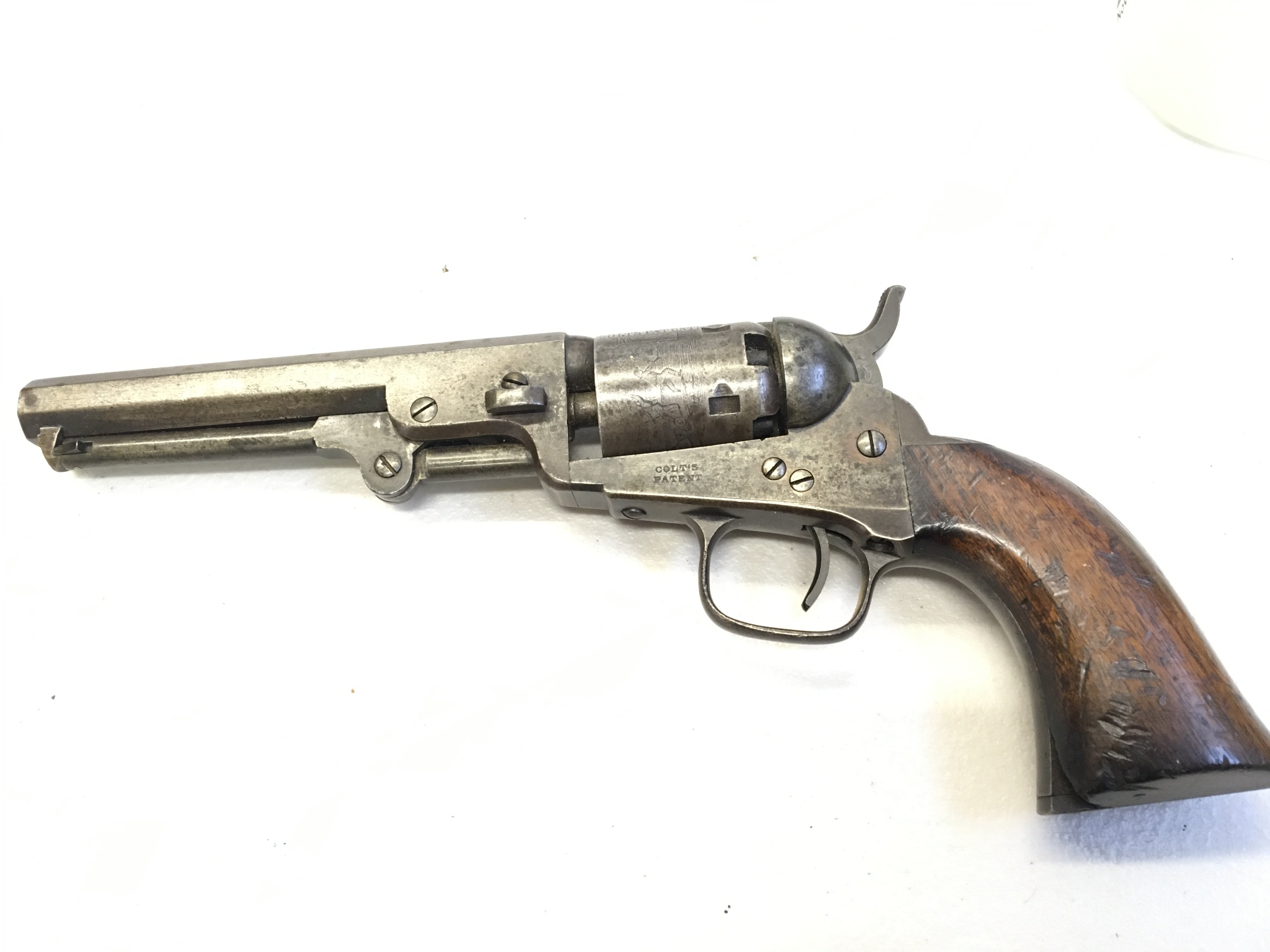 A rare 19th century Colt revolver the octagonal barrel stamped Address Col Colt London the barrel engraved with figures and horse drawn carriage stamped Colts Patent the side plate also stamped Colts Patent.