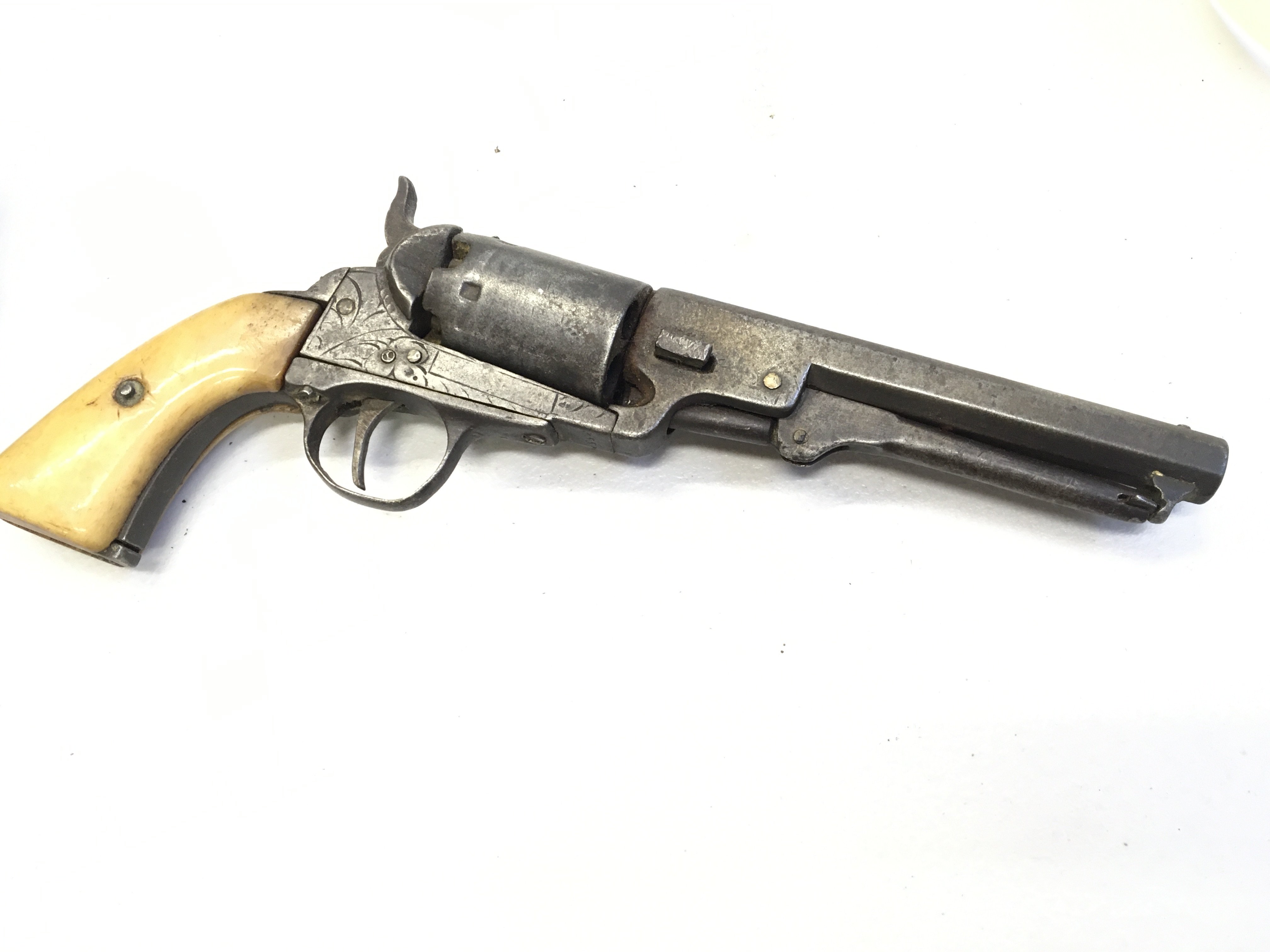 A 19th century percussion pistol with a bone grip with serial number 355 ? Stamped in the underside of the action with light engraving no other markings. action functional.
