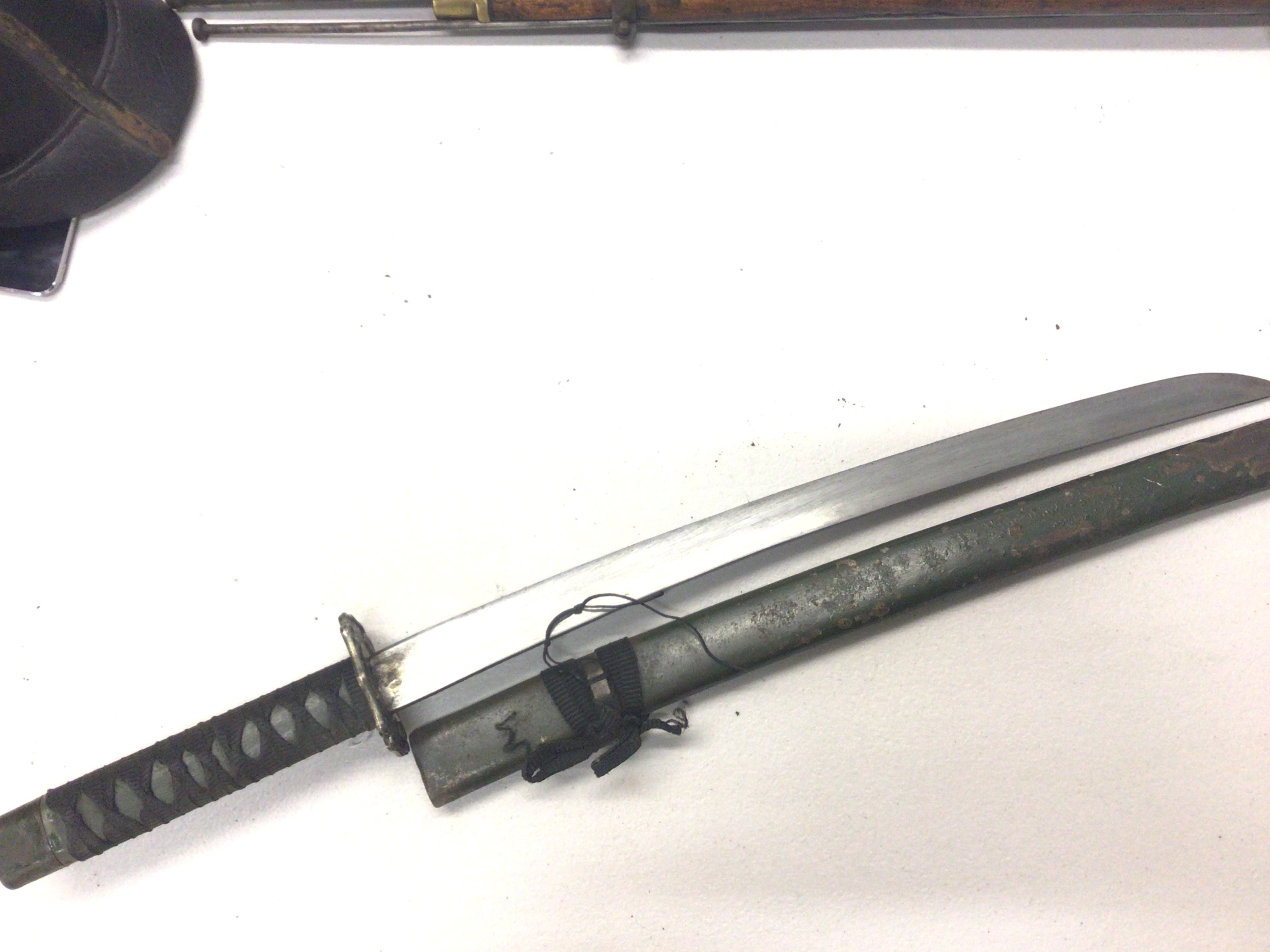 A replica Japanese II world war issue Wakizashi sword with green grip and metal green scabbard.