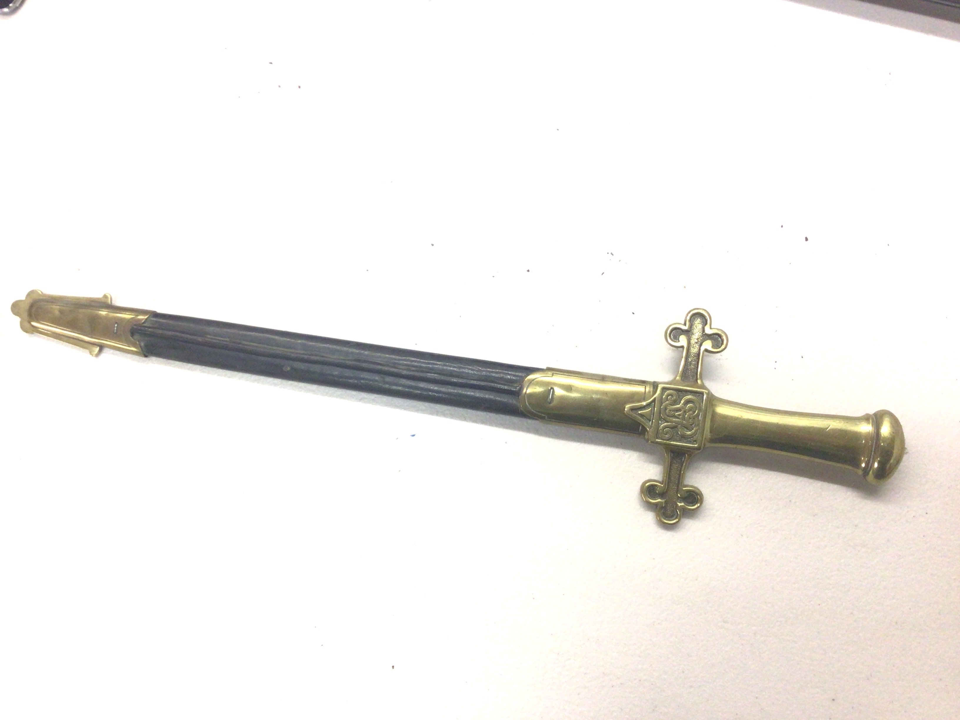 A British George V Drummers short sword with a brass grip and cross bar with Royal Cypher. leather scabbard.