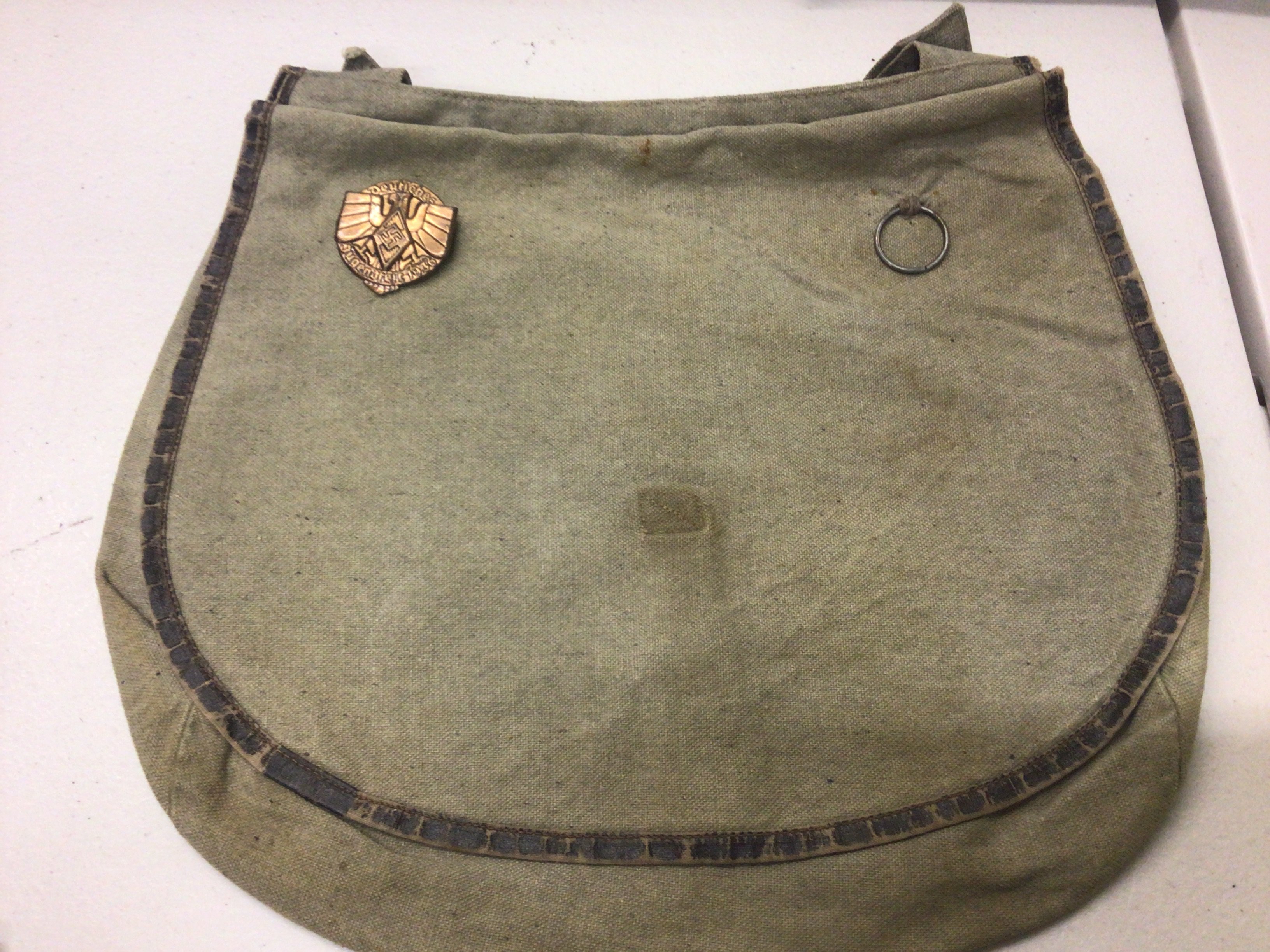 A German Third Reich Hitler Youth bag with 1936 Hitler Youth badge attached.