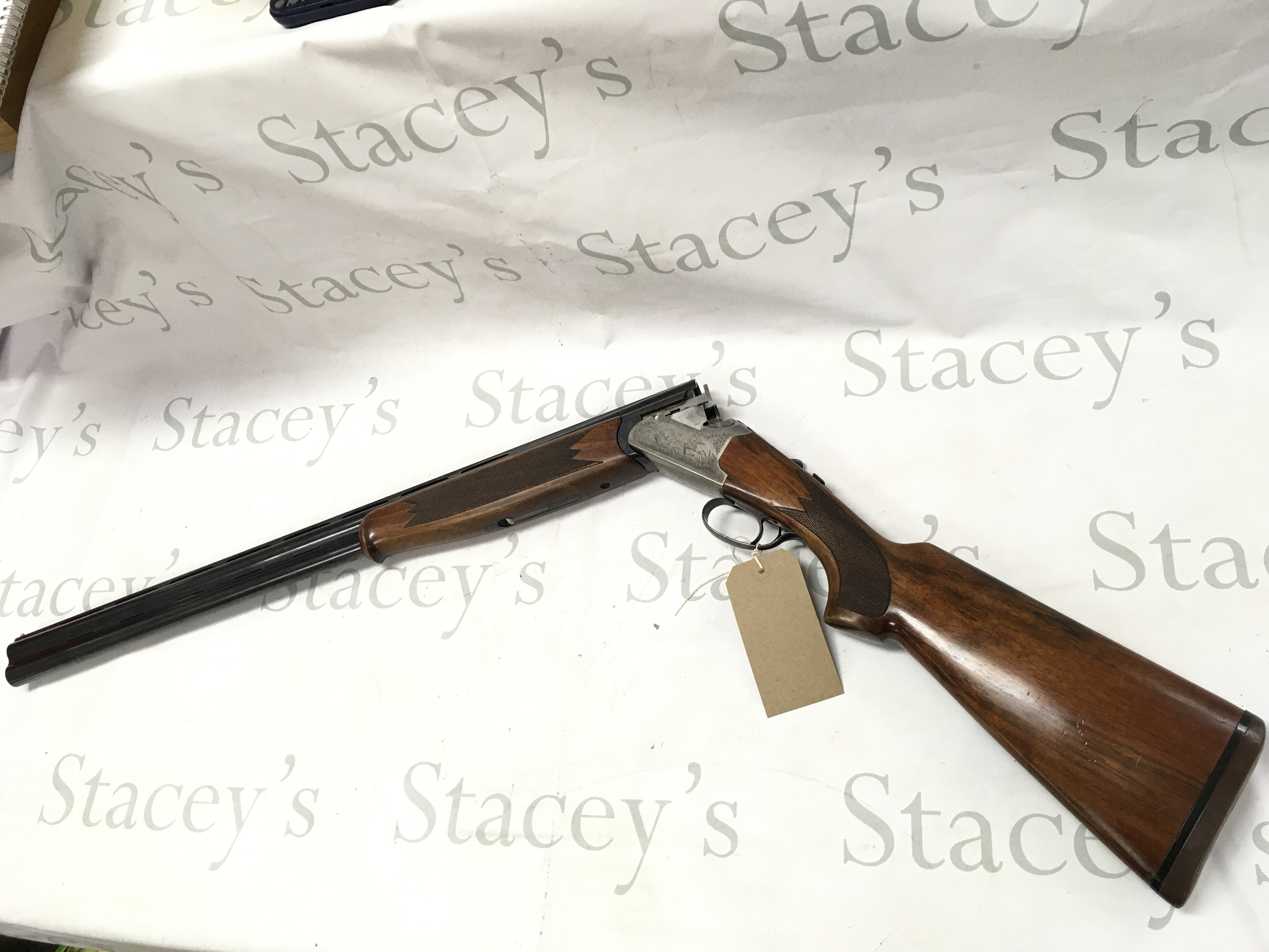 A 12 gauge over under shotgun by Lanber. Single trigger multi choke. 27.5 barrel length and 44.5 inches overall. Serial number 286011 -12 - 70 PLEASE NOTE THAT A SHOTGUN LICENSE IS REQUIRED TO PURCHASE THIS ITEM. COLLECTION AND VIEWING BY APPOINTMENT ONLY.
