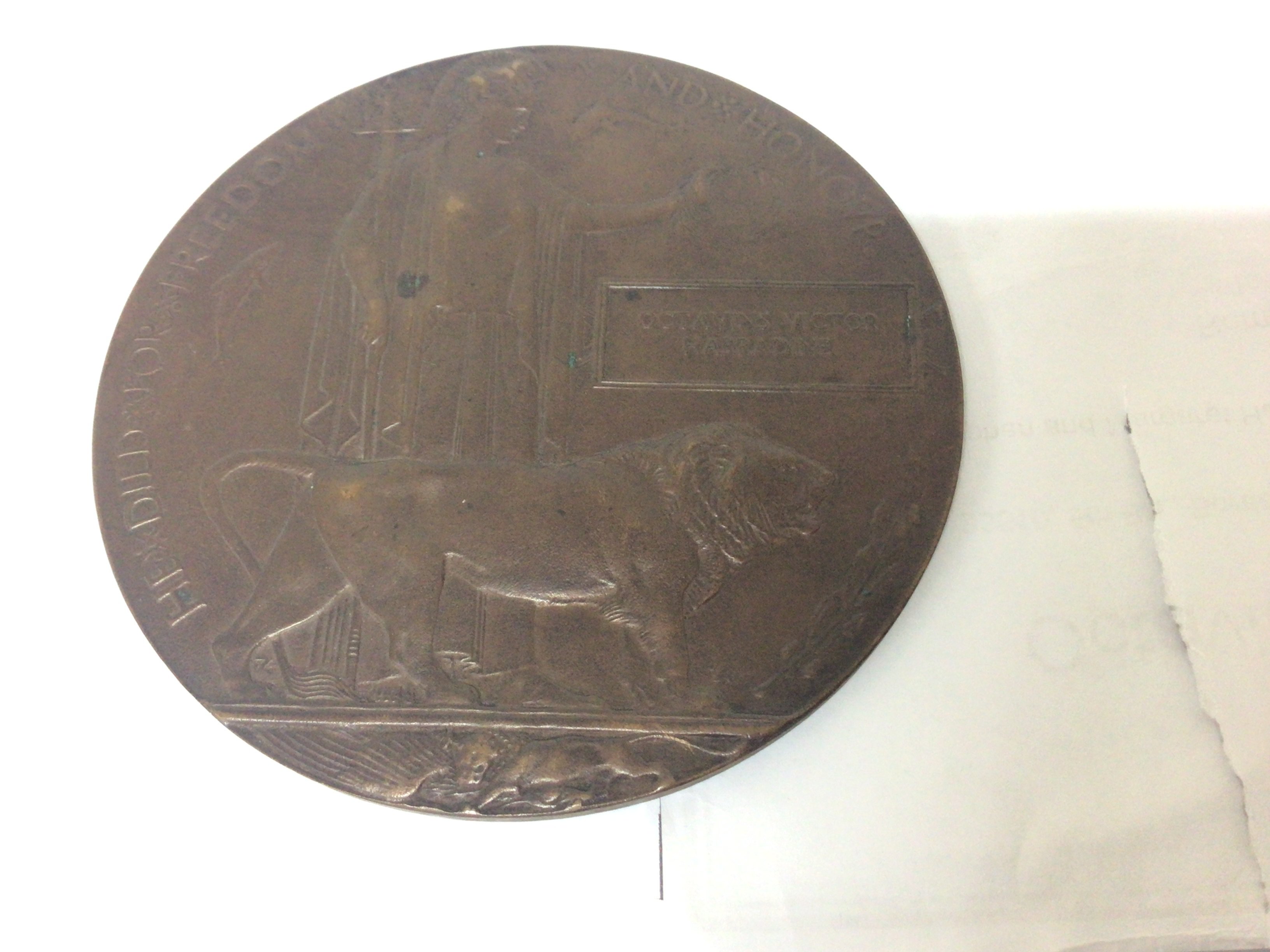 A Bronze memorial plaque awarded to Octavians Victor Harradine 33510 5th Bt Border Regiment killed on the 10th August 1918.