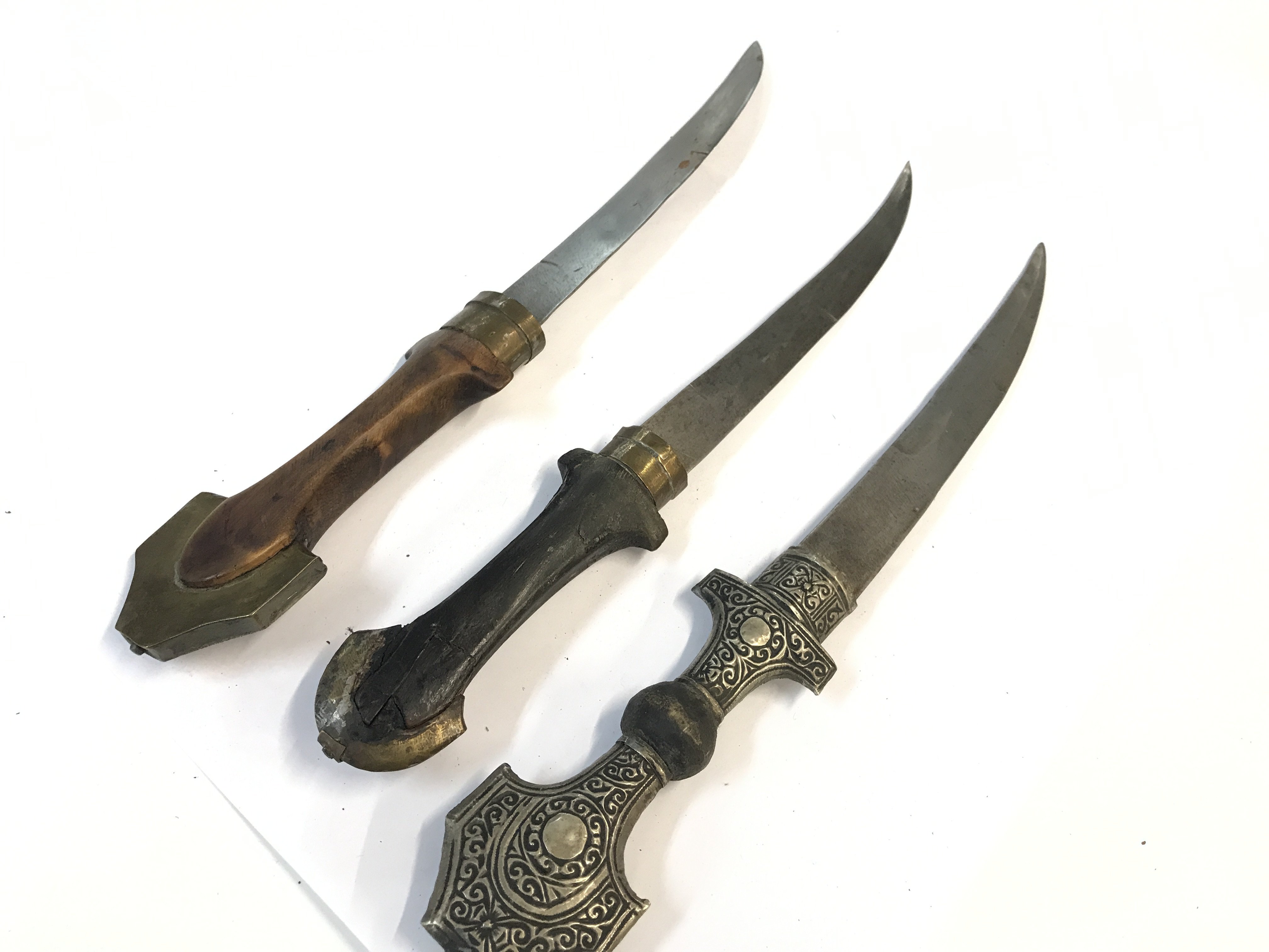 Three Moroccan Trina Koummya Daggers with brass and silvered scabbards (3)
