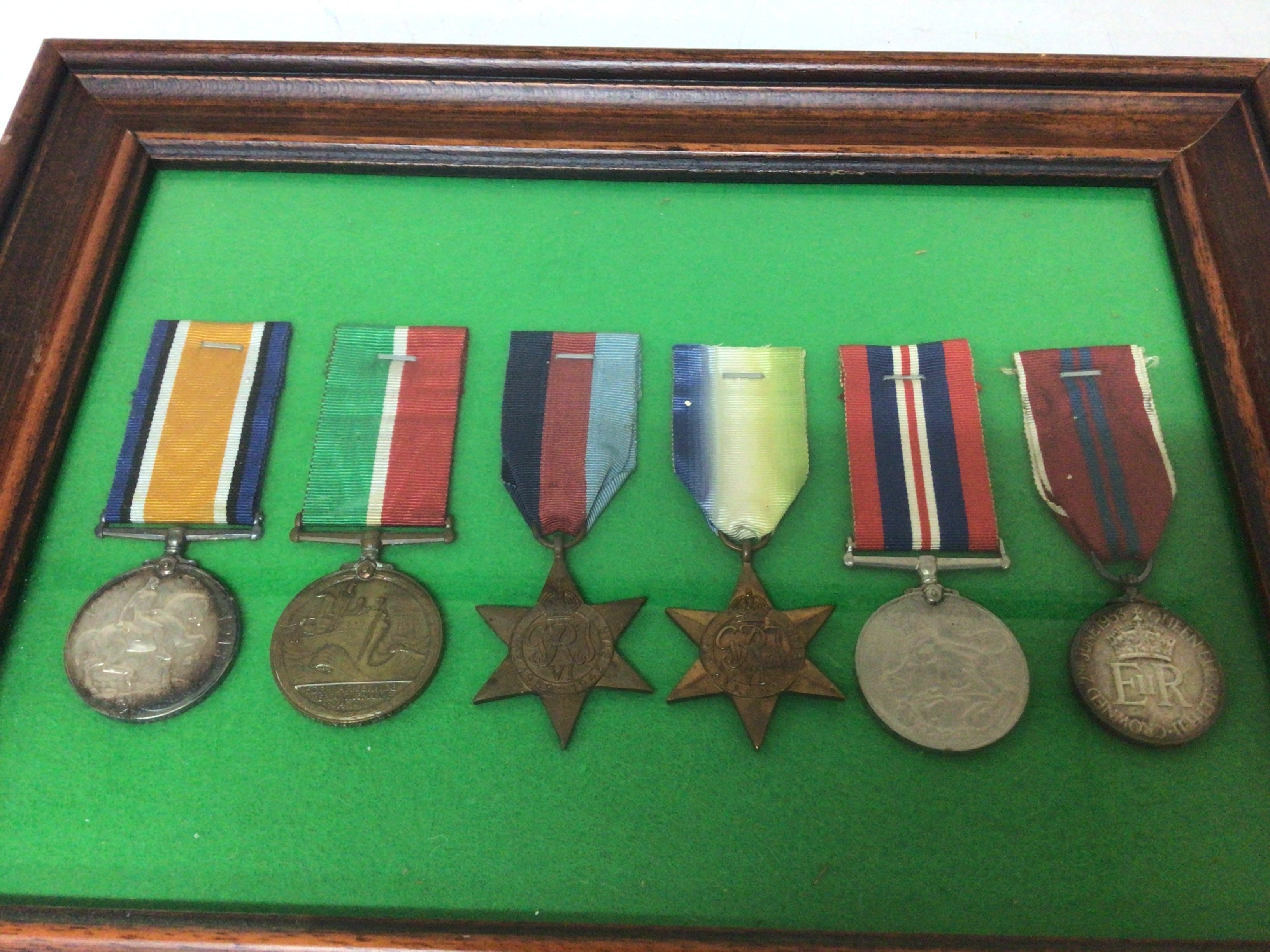 A sealed frame containing six medals 1914-1918 I world war medal a Mercantile medal 1939-45 star Atlantic star 1935-45 Victory medal and an Elizabeth II Coronation medal (6)