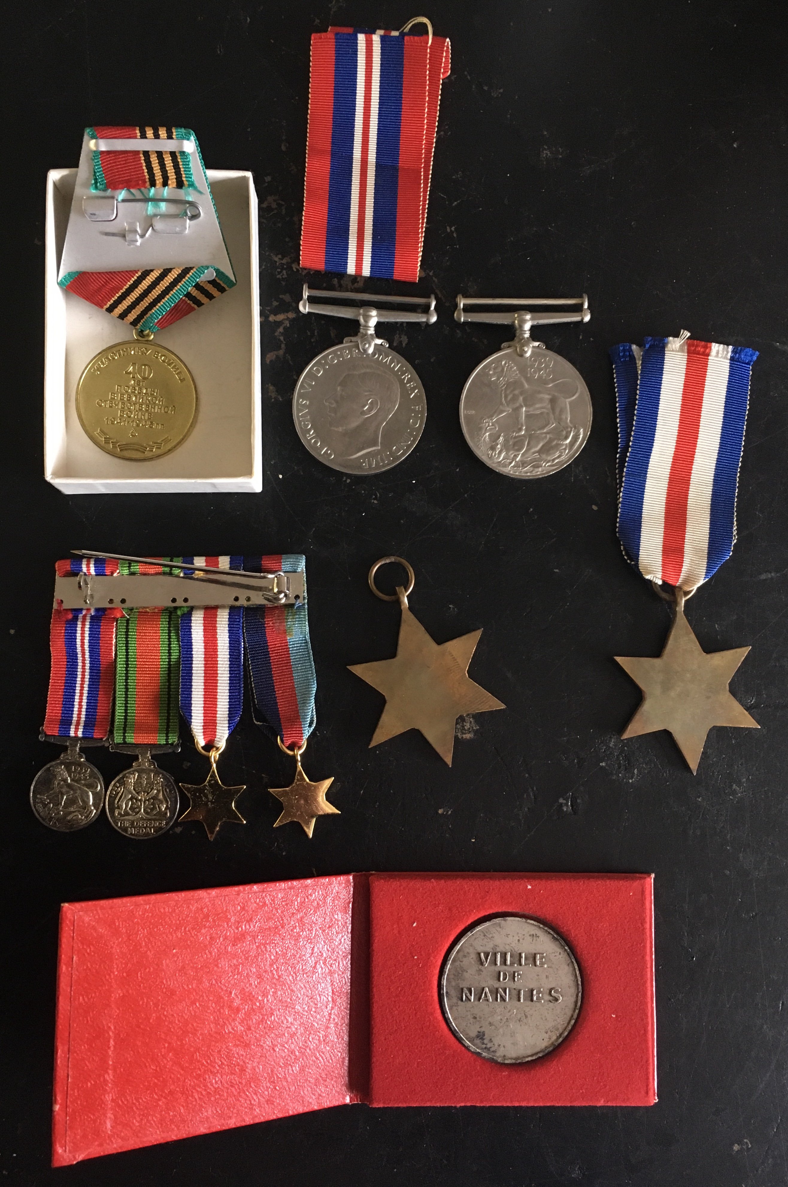 A Group of II World War Medals: Victory Defence France German Star and 39/45 Star with a matching group of miniature dress medals a commemorative Nantes medal. Instructions to sell.