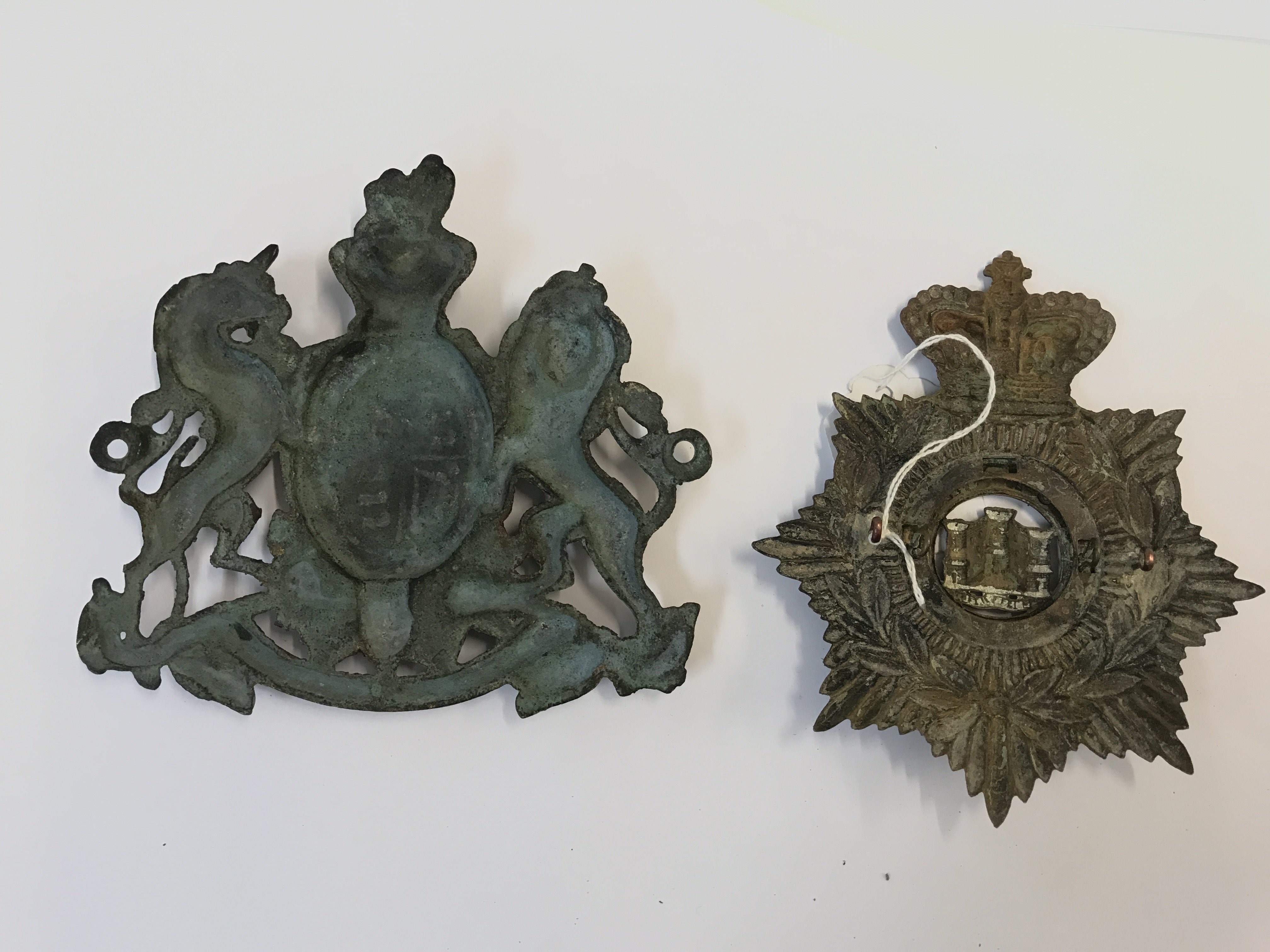 Devonshire helmet plate and a brass coat of arms plate . Postage category B