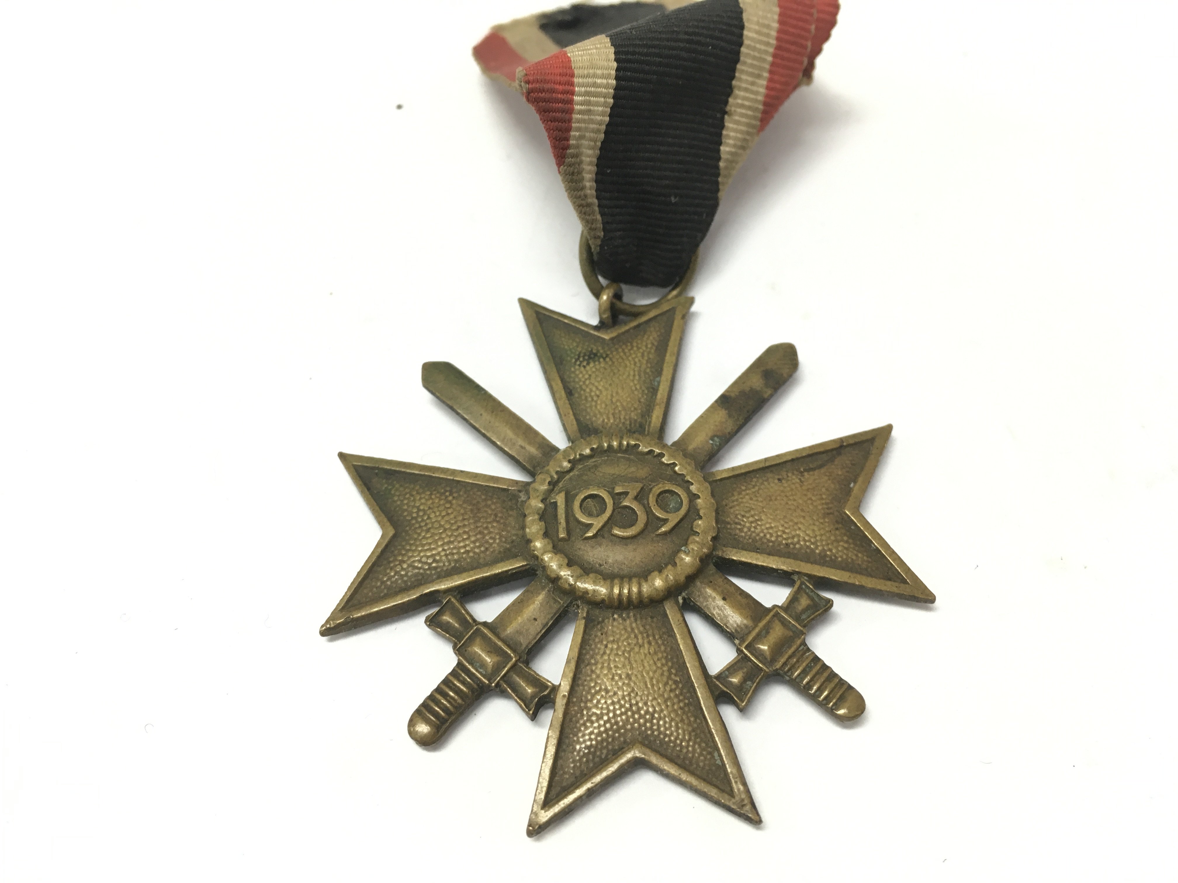 A German Third Reich war merit cross, 1939 and a collection of shield badges including Narvik 1940. postage category A