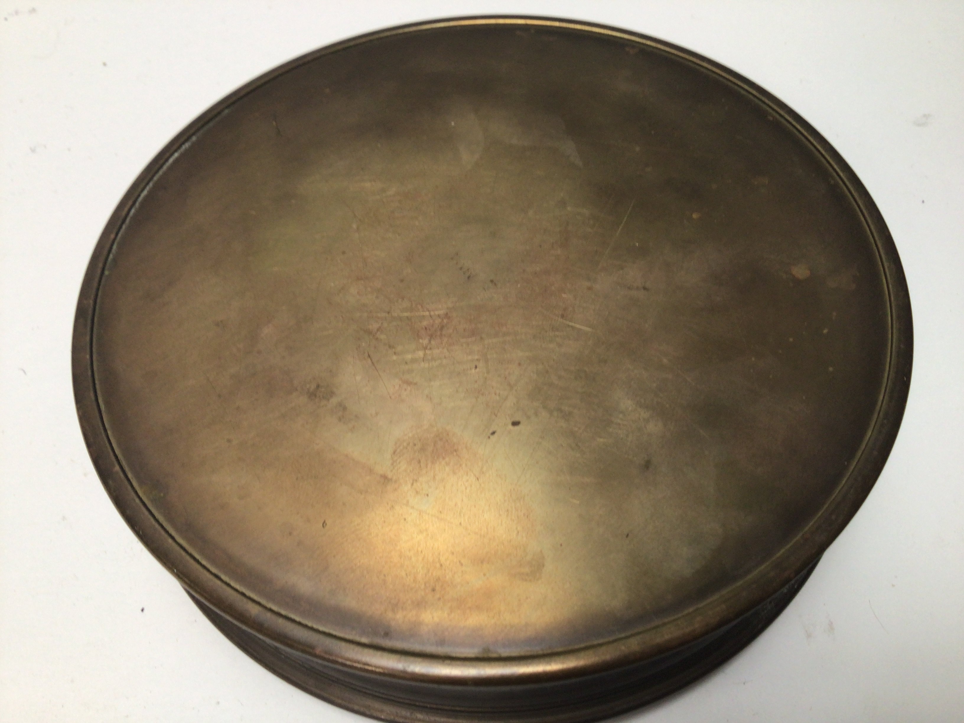 An American brass container of circular shape.