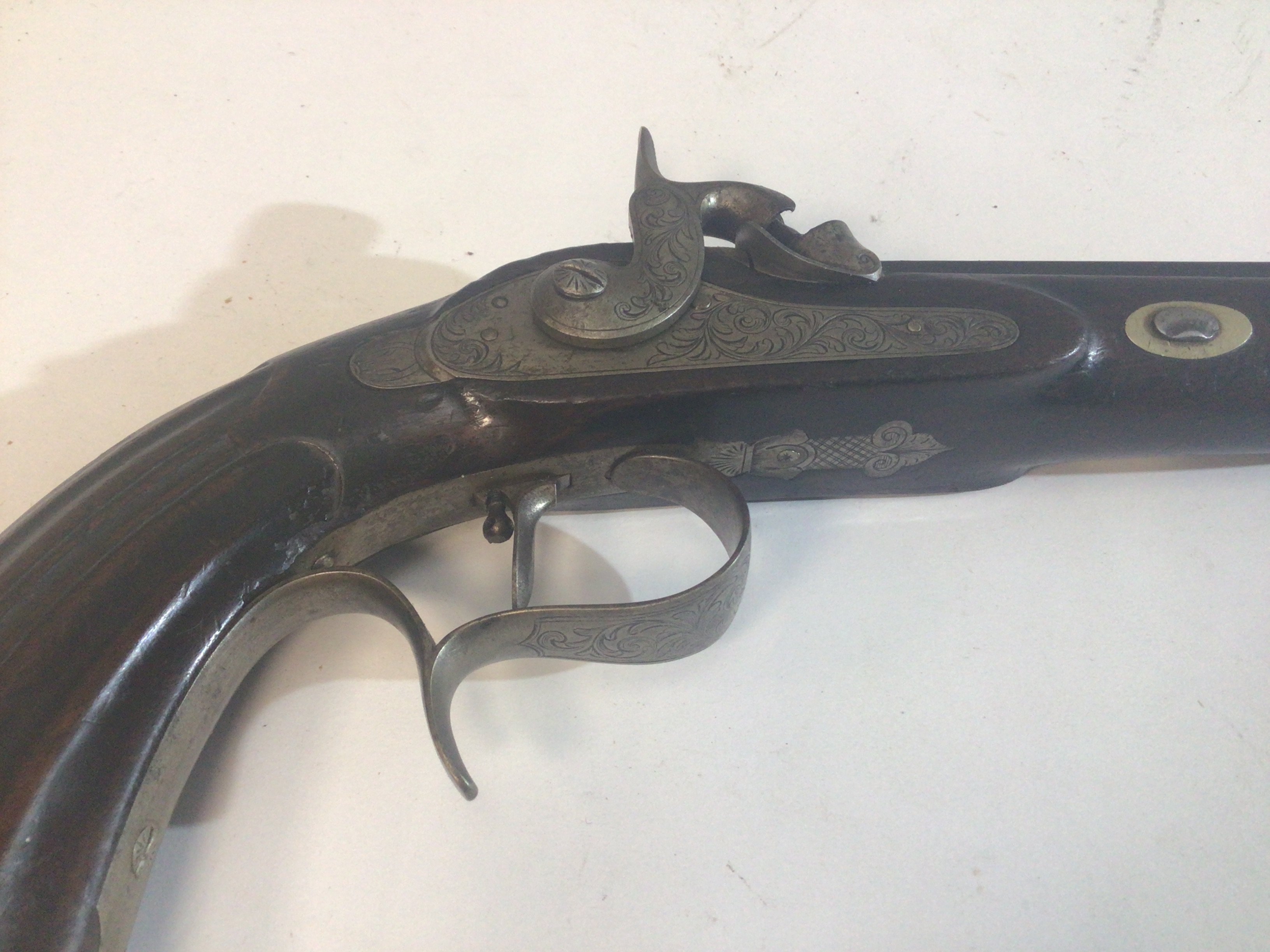 A 19th Century French Percussion Target Pistol or dulling pistol with walnut carved grip with an octagonal Damascus barrel. Engraved steel action Le Fever. The action works.