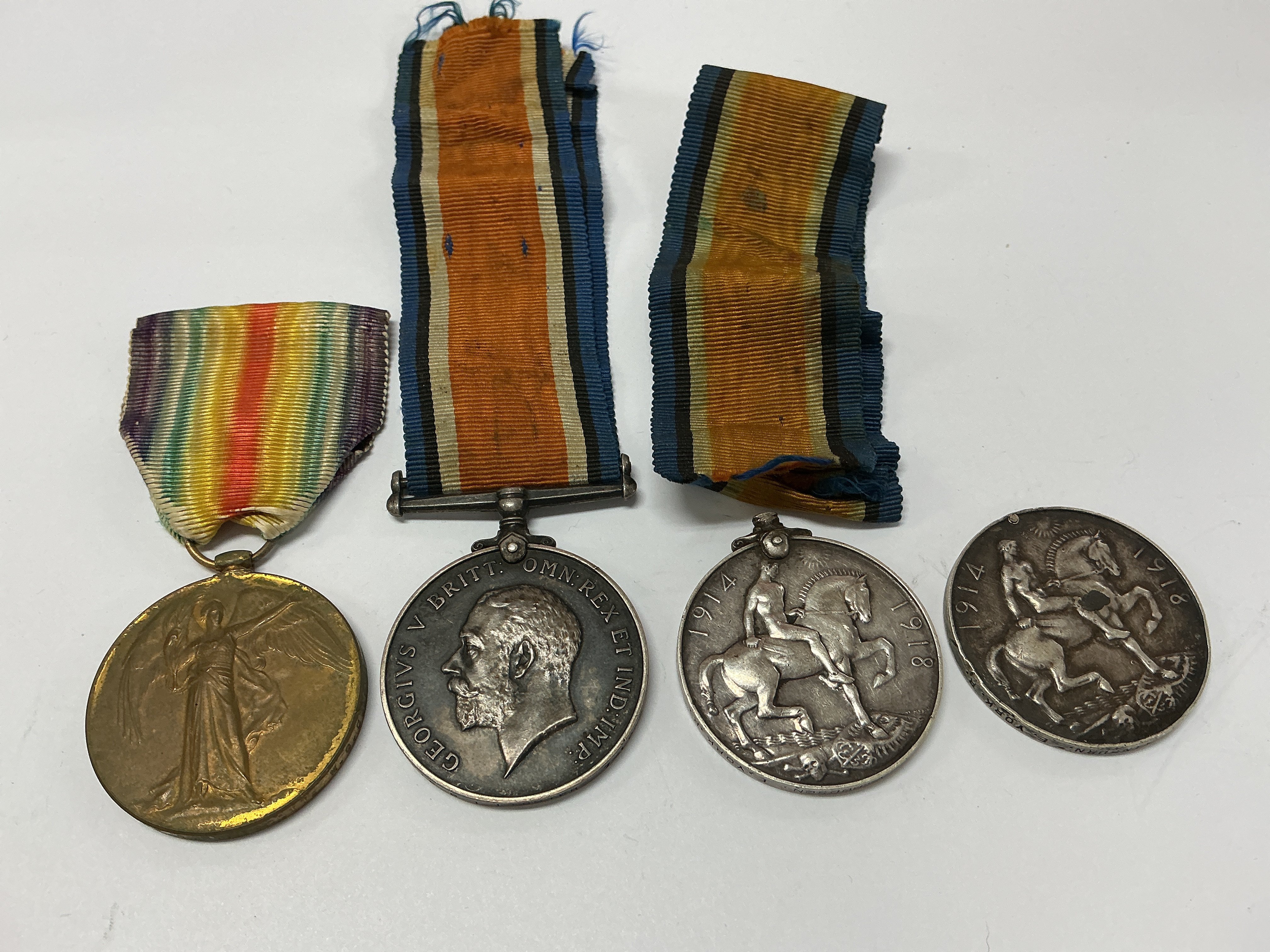Group of four WW1 medals. 121925 PTE. T. E. PESCOTT. M. G. C. 1914-1919 (1). G- 97194 PTE. B. I. LIGHTER 7- LONDON. R 1914-18 (2). 204186 PTE. V. HUDSON. E. YORK . R. 1914-18 (3). 1806 PTE. J. H. SWINBURNE. E. YORK . R. 1914-18 (4).