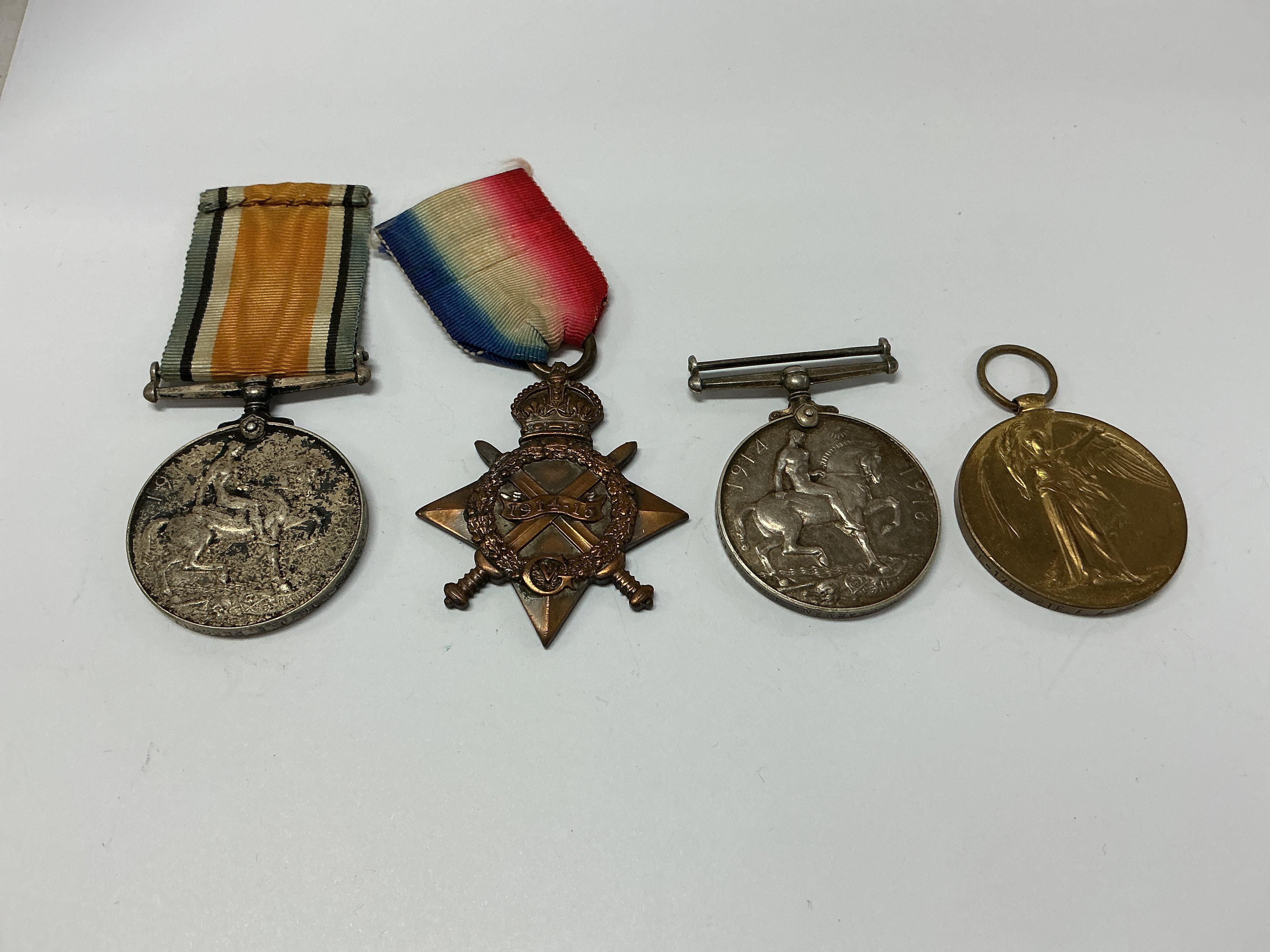 Group of four WW1 medals. 121925 PTE. T. E. PESCOTT. M.G.C. 1914-18 (1). 118489 PNR. J. PARKER. R.E. 1914-15 Star medal (2). G-11803 PTE. D. G. DEARMAN. THE QUEENS R. 1914-18 (3). SE-1785 PTE. F. A. REYNOLDS A. V. C 1914-19 (4).