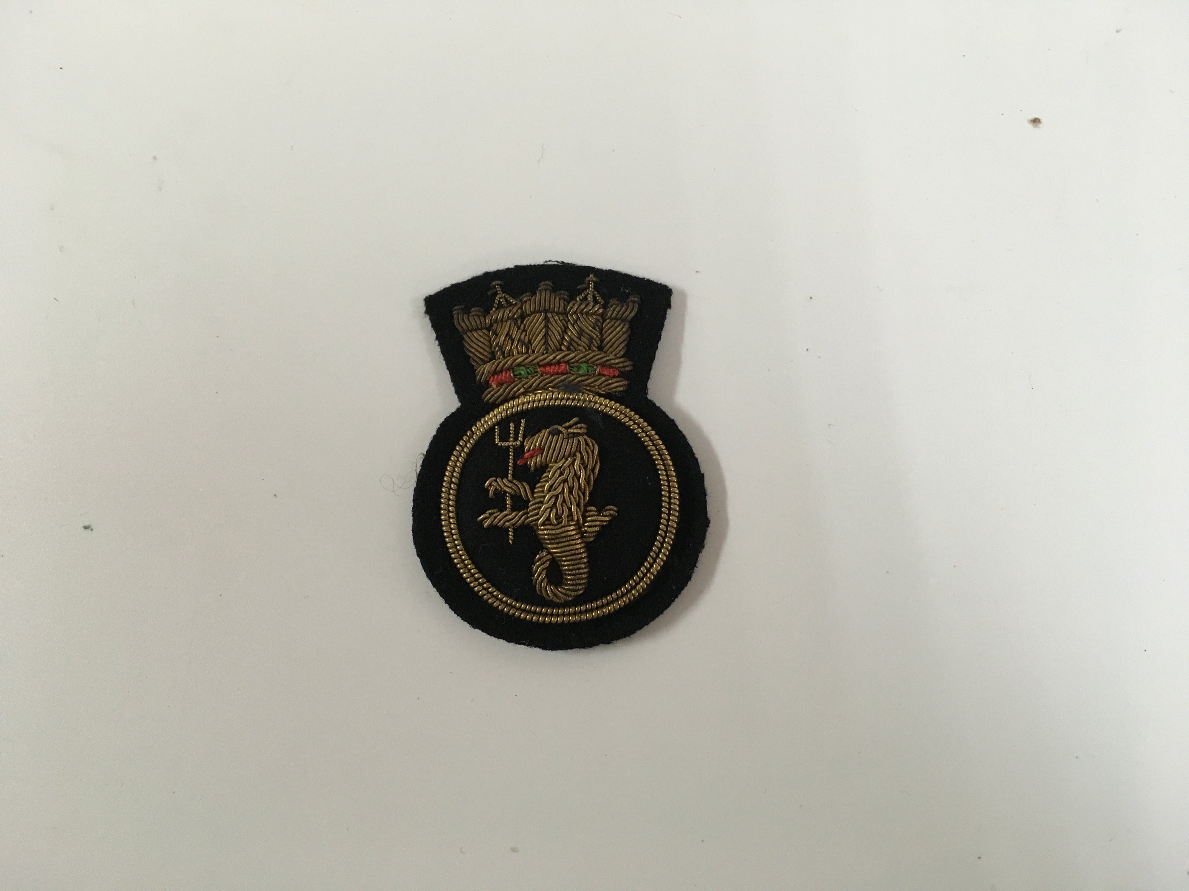 A collection of uniform badges consisting of very early type officers badge from the royal yacht association, Union castle/clan line shipping company cap badge, uniform badge from the civil defence corps, royal naval blazer badge circa 1950s, pair of original design jacket badges from the orient line and superb set of royal naval uniform badges