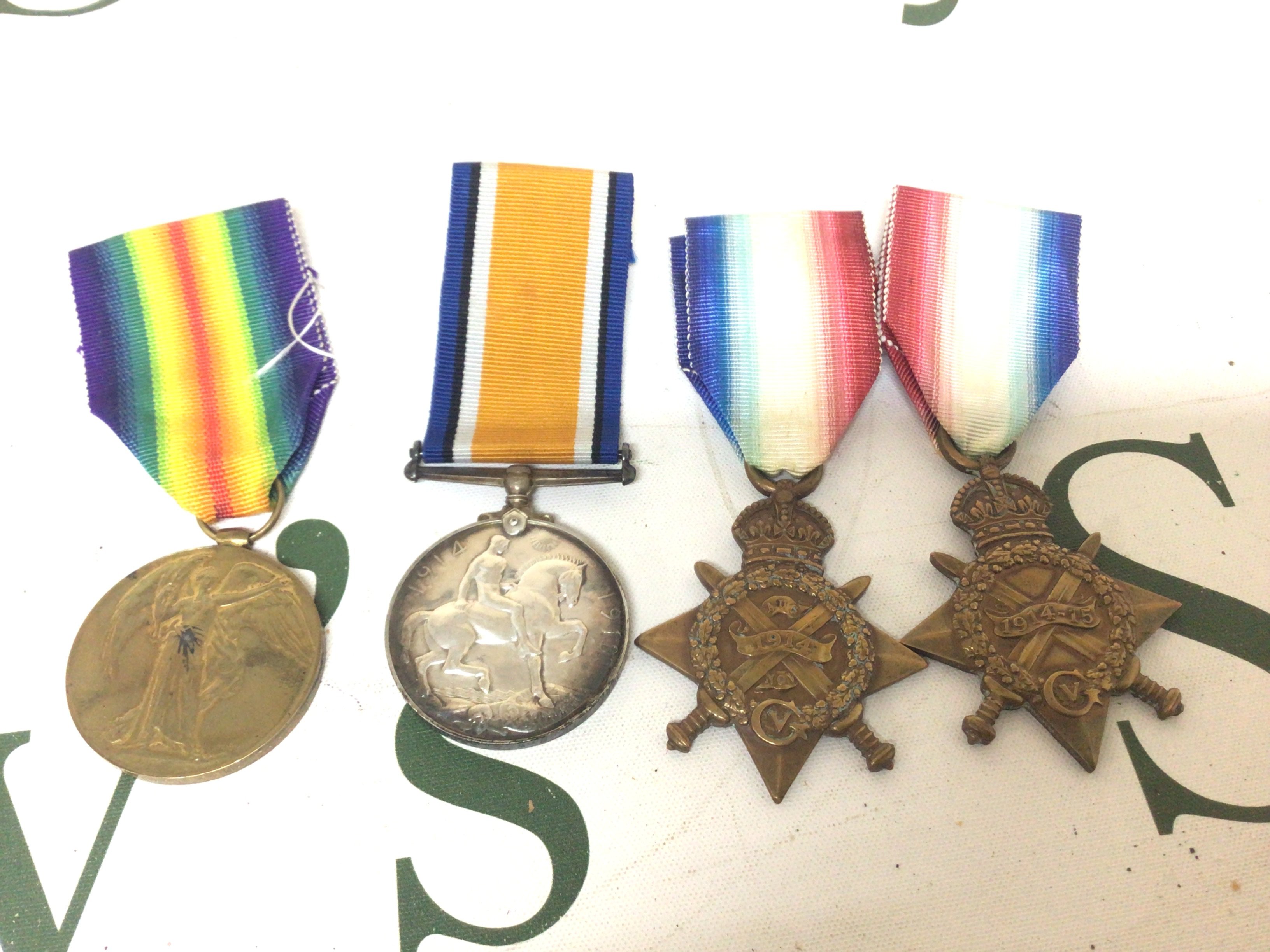 A Group of three I world war medals awarded to 4060 PTE R W Gibson R Fus. and a 1914 star awarded to 1745 Pte S Hunter 2/s LanR. (4)