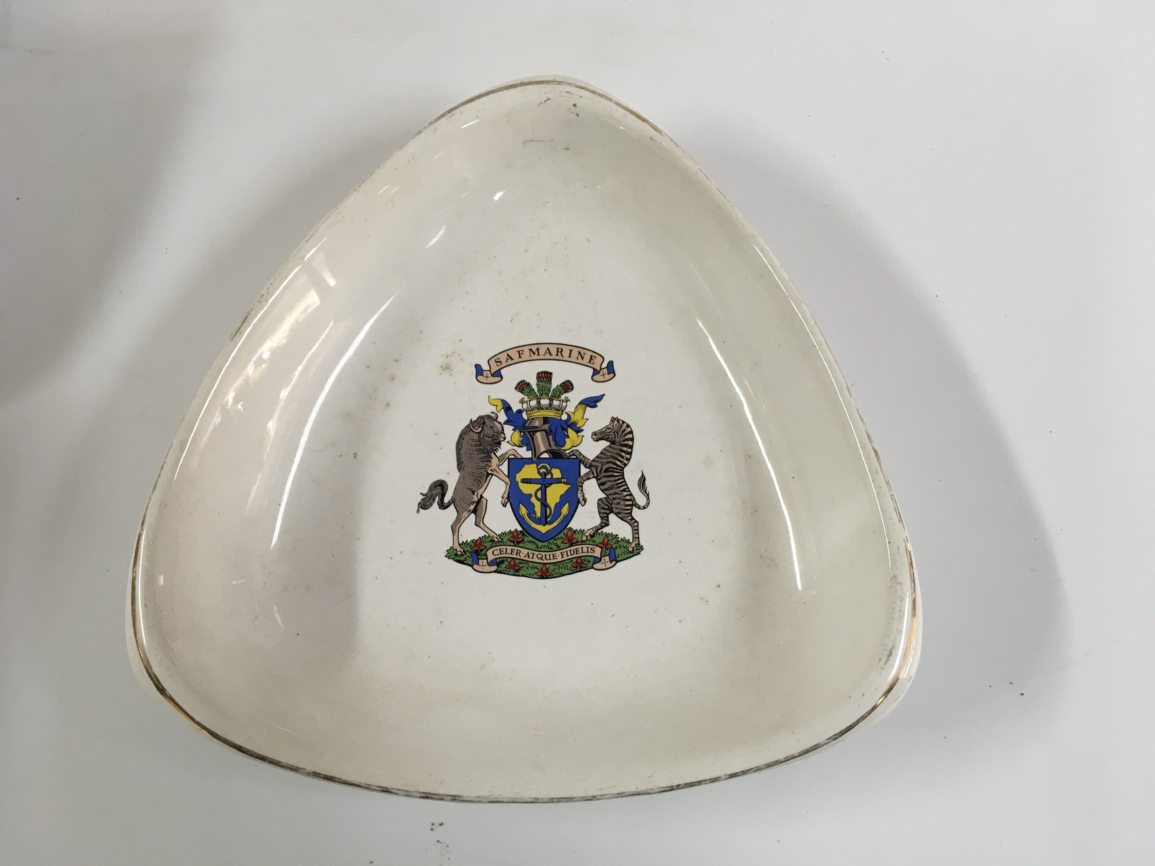 Collection of merchant shipping items consisting of early 3-sided China dish from South African marine line, small floral China dish from the Dresden line paddle steamer company circa 1930s, original American president line picture ashtray, ships China bowl from the Dalgeish steamship company and rare shipping company half moon China serving plate from the palmer line