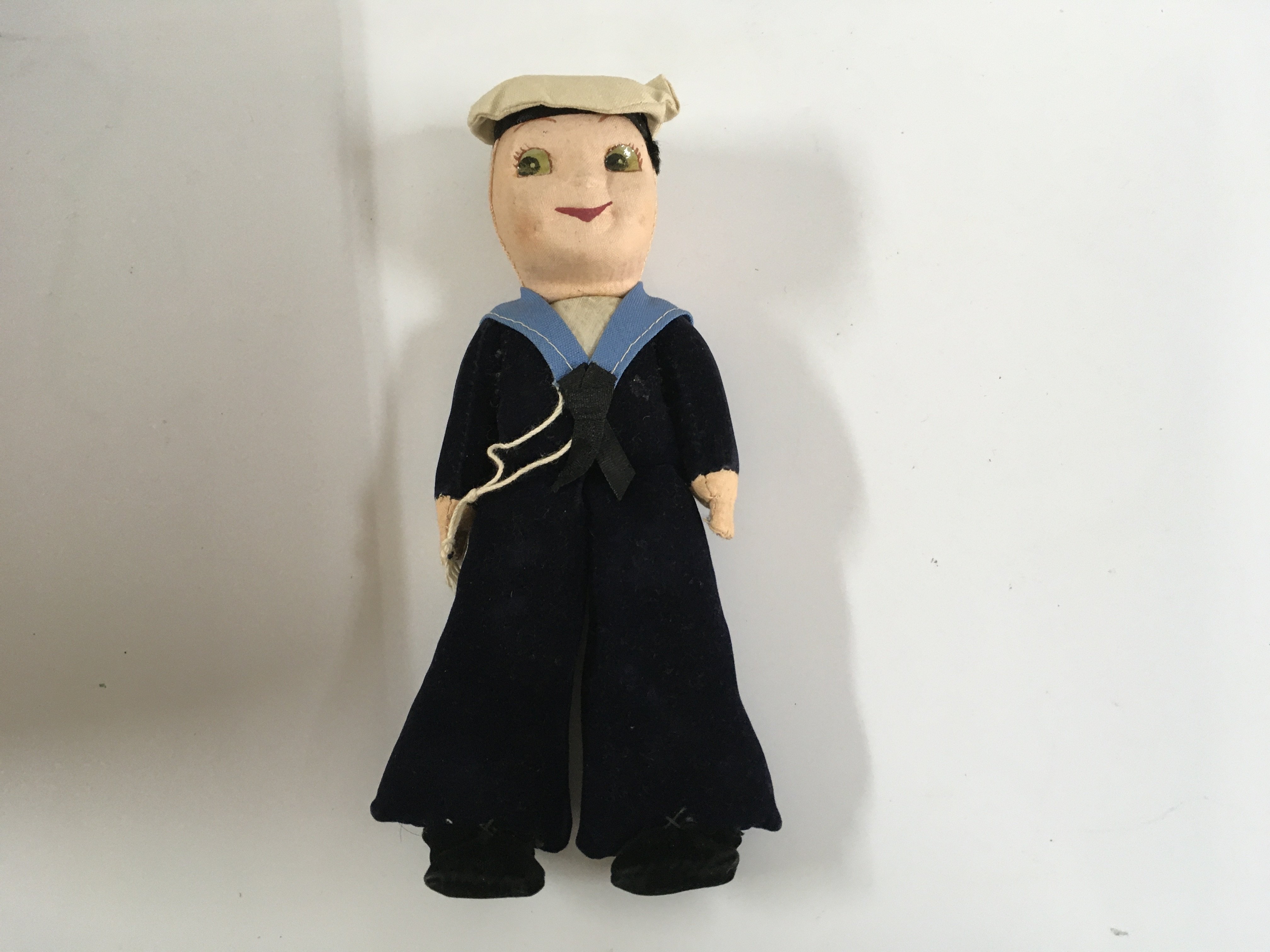 A collection of miscellaneous great liners items consisting of an as used on board ashtray from SS Cavina from the elders and fyffes line, Wedgewood souvenir from the vessel the royal yacht Britannia, posted envelope from the RMS Polaris dated 1908, sailor doll souvenir from the vessel the SS Ithaca, silver coloured napkin ring from the Nelson line vessel the SS Highland Glen and silver plated dining table salt & pepper pot from the Aberdeen & commonwealth line vessel the Diogenes