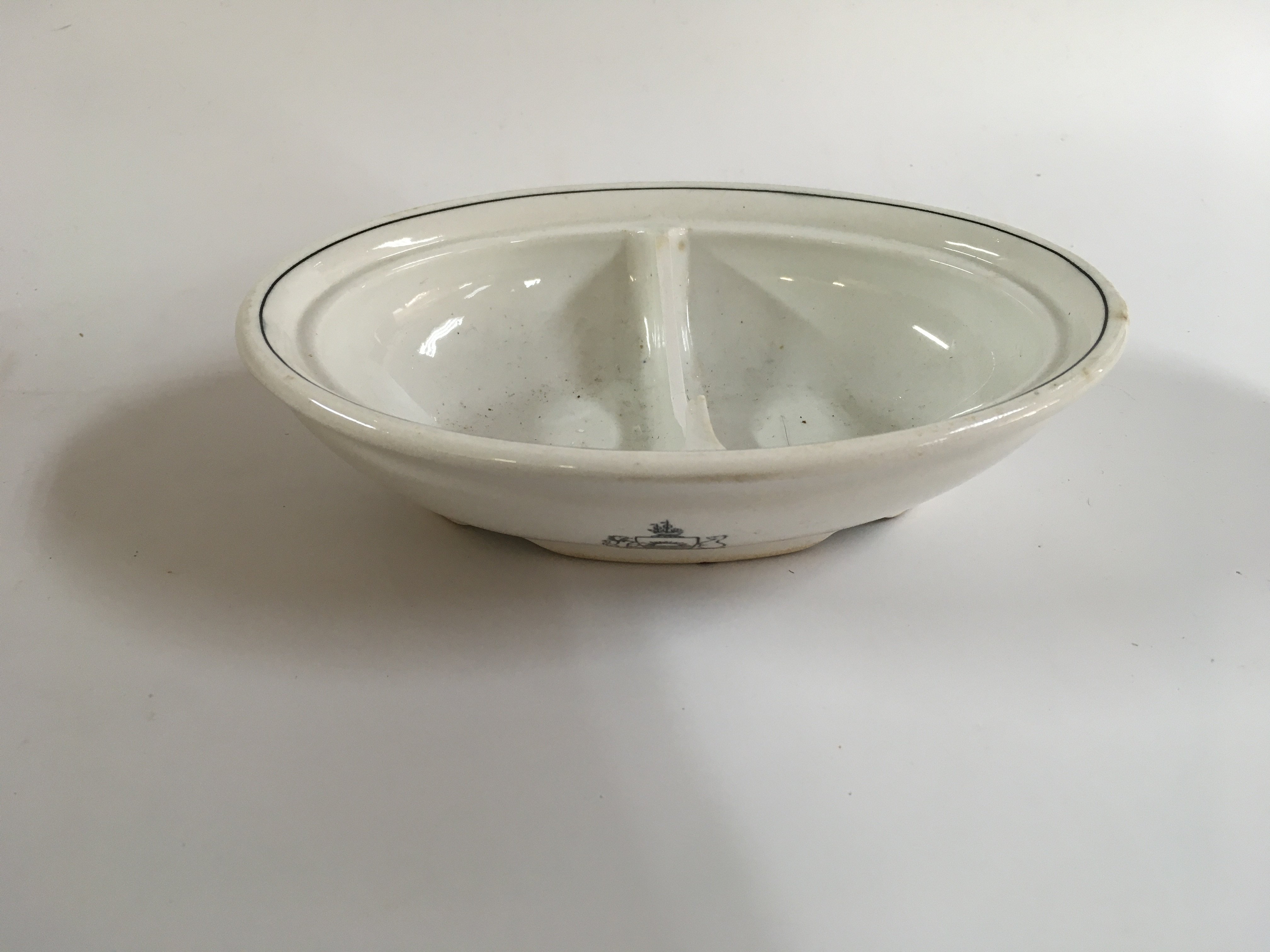 A collection of orient line items consisting of Wedgewood design side plate as used on board the orient line, very rare to find early souvenir ashtray from the orient line vessel the SS Orvieto, very early piece of steamship China from the orient line, small souvenir tankard from the orient line vessel the RMS Orcades, Seashell design large dinner bowl from the orient line and original glass cabin dish from the orient line shipping company circa 1950s