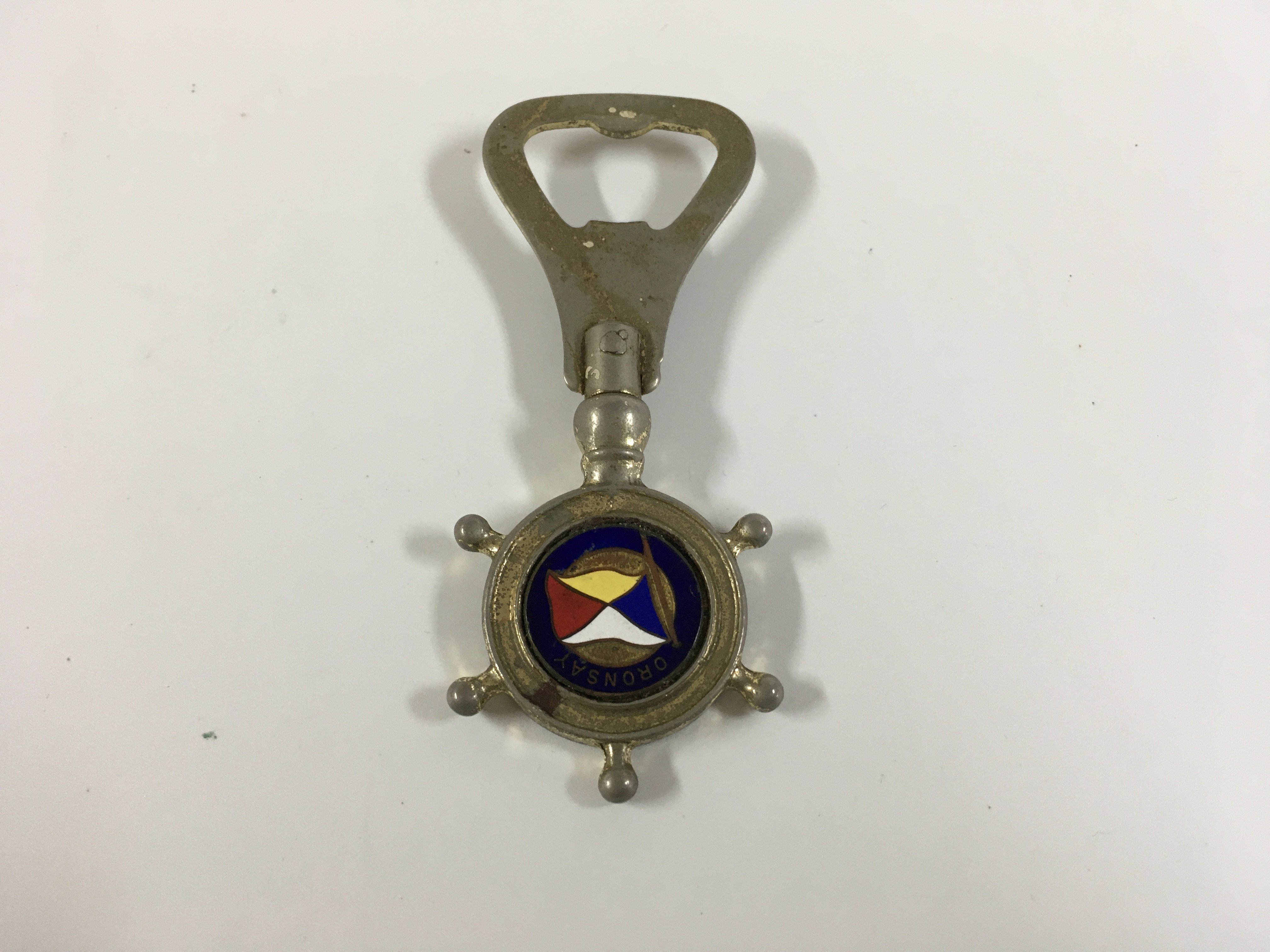 A collection of orient line items consisting of as new sailor doll souvenir from the orient line vessel the SS Orsova, as used in service orient line shipping company dining plate, bottle opener from the vessel SS Oronsay, original as used in service coffee cup and saucer from the orient line, original as used on board orient line seashell design dining side plate, original ships accommodation plan for the RMS Ormonde of the orient line from 1924