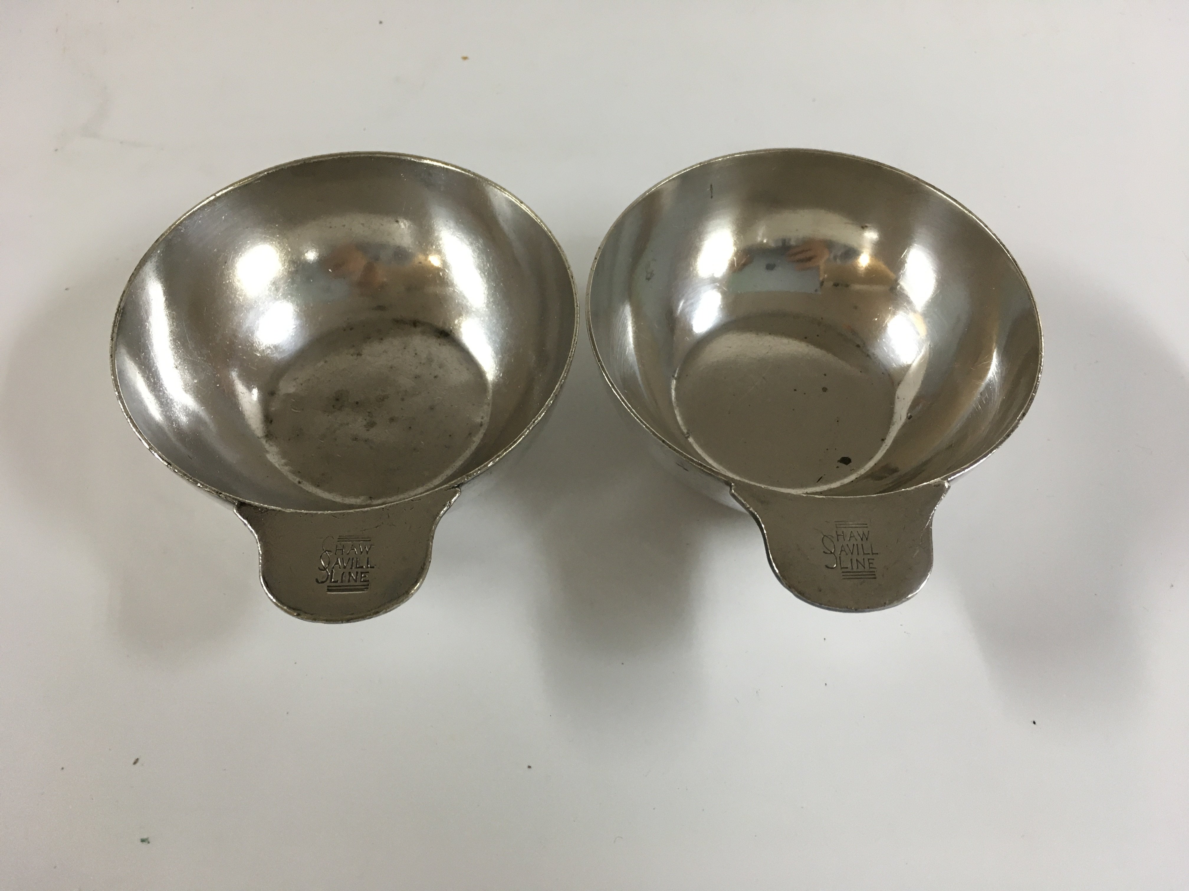 Collection of shaw savill & Albion line items consisting of as used in service early type sugar bowl, as used onboard large embossed tablecloth, as used in service soup serving dish, early souvenir letter opener from the vessel the ocean monarch, wooden dish souvenir from the vessel SS Athenic and souvenir spoon from the vessel SS Oceon monarch