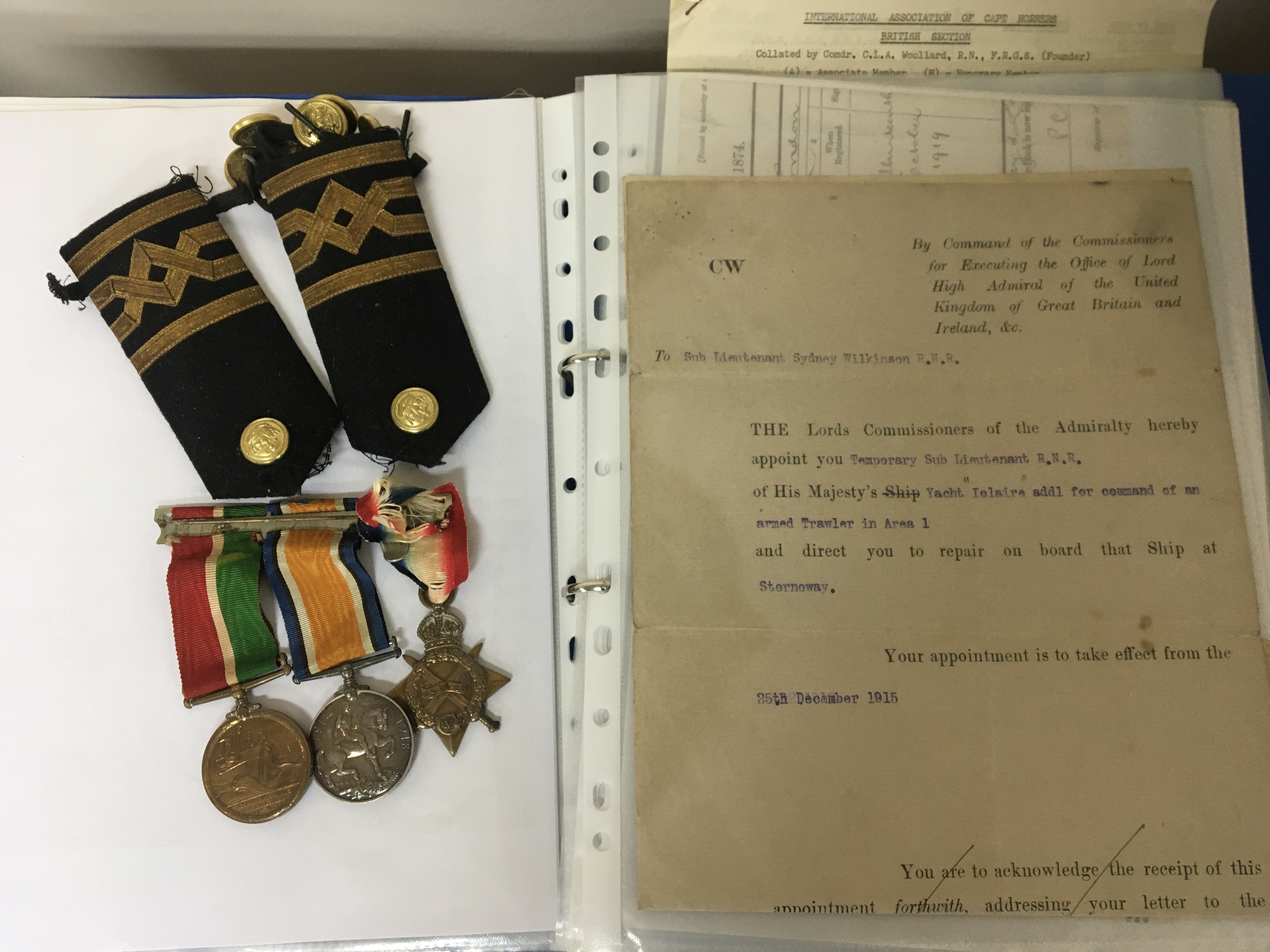 A Group of I world war medals awarded to Sub Lieutenant S Wilkinson RNR. Including 1914-15 star wartime Mercantile medal and British War Medal sold with epaulets buttons and a folder containing History of S Wilkinson.