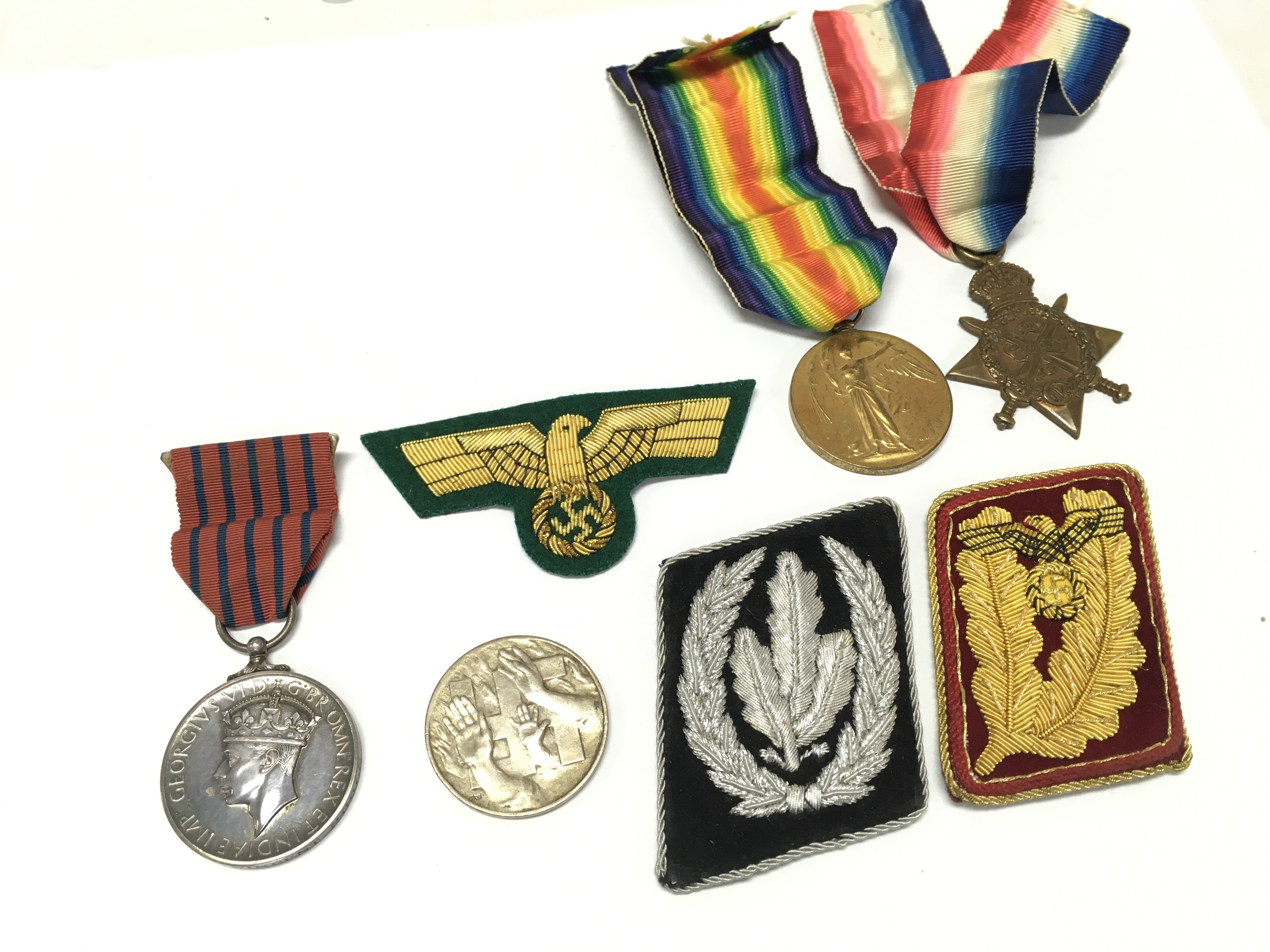WITHDRAWN - A Collection of medals including a NSDAP German Reichstags WAHL 1932 medal, WW1 medals 1914 star and victory medal presented to 44522 GNR. A.H . POOLE . R.F.A , George Medal presented to a Bertie Vincent Poole . German cloth rank badges. Postage category A