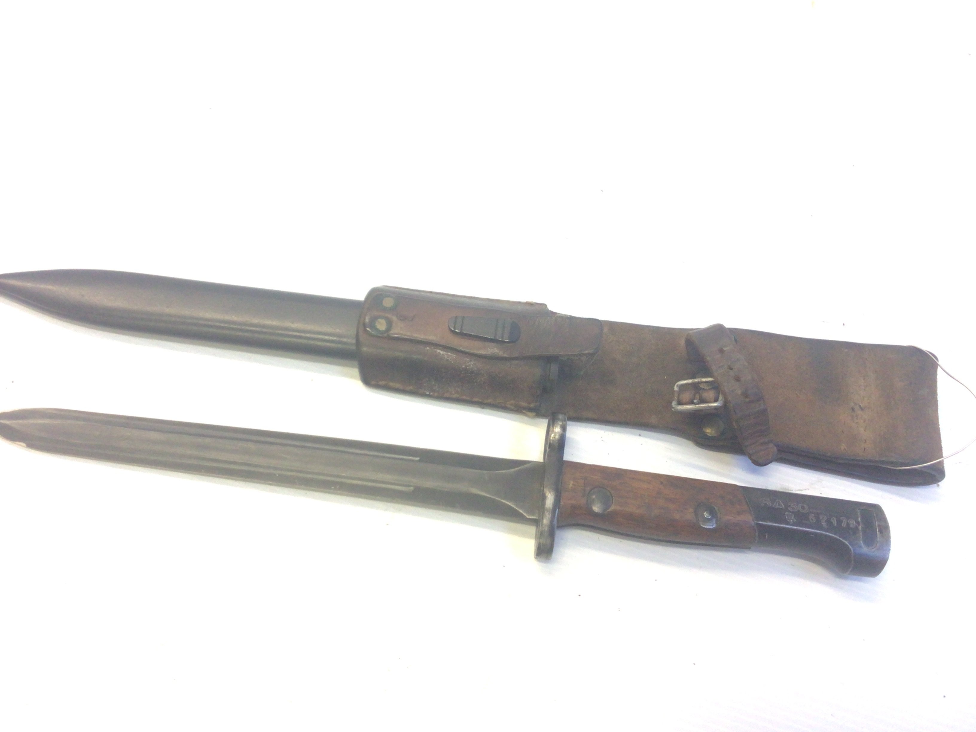 An intresting II world war period bayonet possible Portuguese stamped SA30 with crown serial number 62179 with steel scabbed. With leather frog attached.