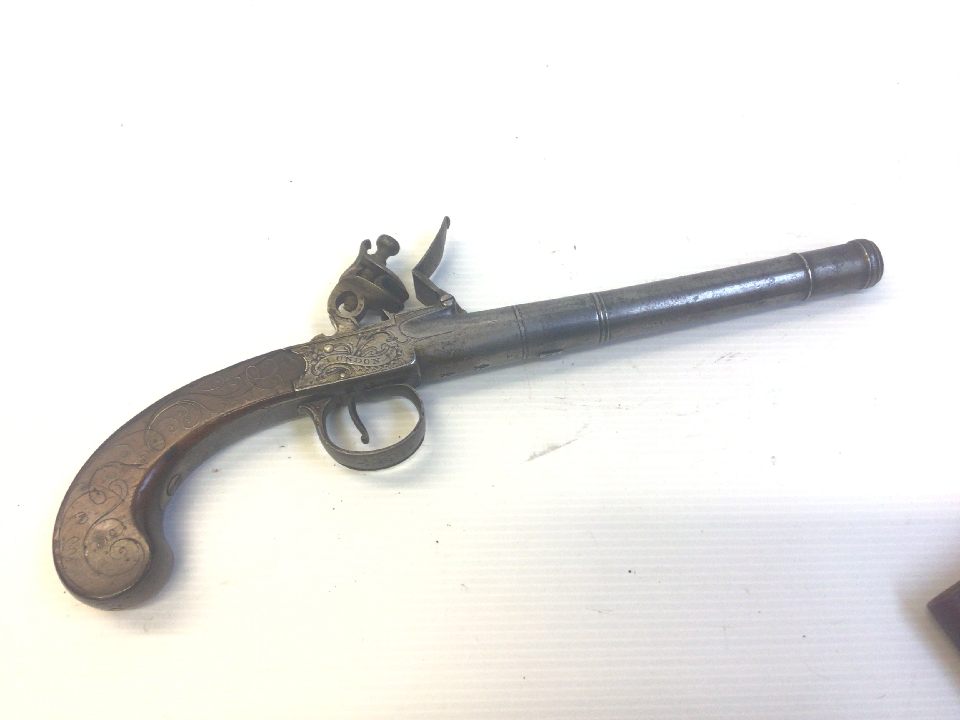 An 18th century flintlock pistol with extended cannon steel barrel the action stamped I Oiner London. The walnut grip with slivered inlay action functional proof marks to the barrel. Length 33cm